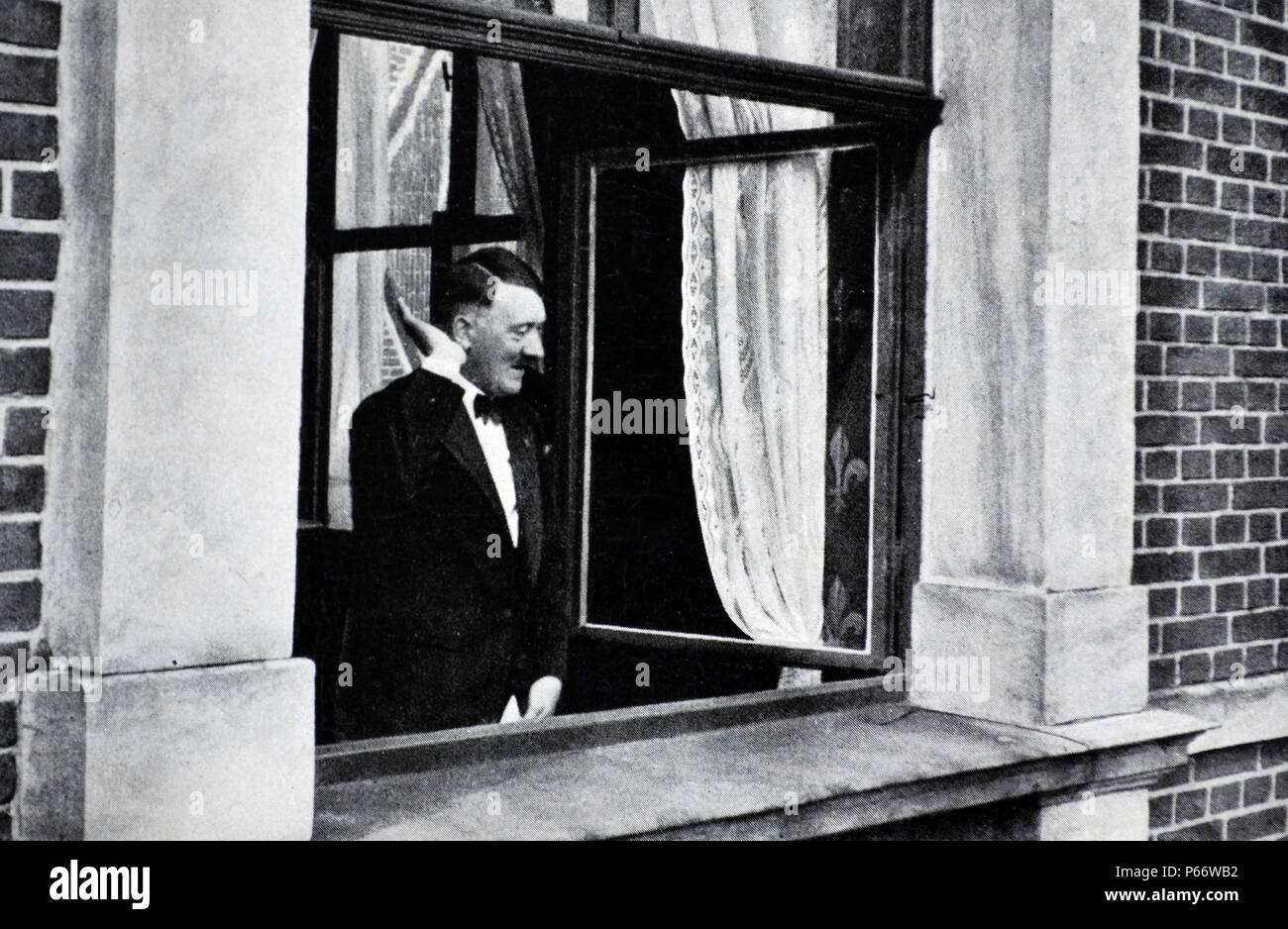 Adolf Hitler 1889-1945. German politician at a window receiving the adulation of a crowd in Bayreuth Stock Photo