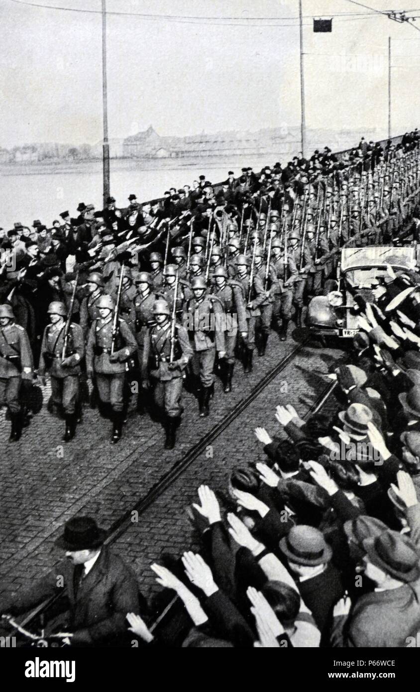 German army enters the Rhineland to salutes from civilians. The remilitarization of the Rhineland by the German Army took place on 7 March 1936 when German military forces entered the Rhineland. This was significant because it violated the terms of the Treaty of Versailles and the Locarno Treaties, marking the first time since the end of World War I that German troops had been in this region Stock Photo