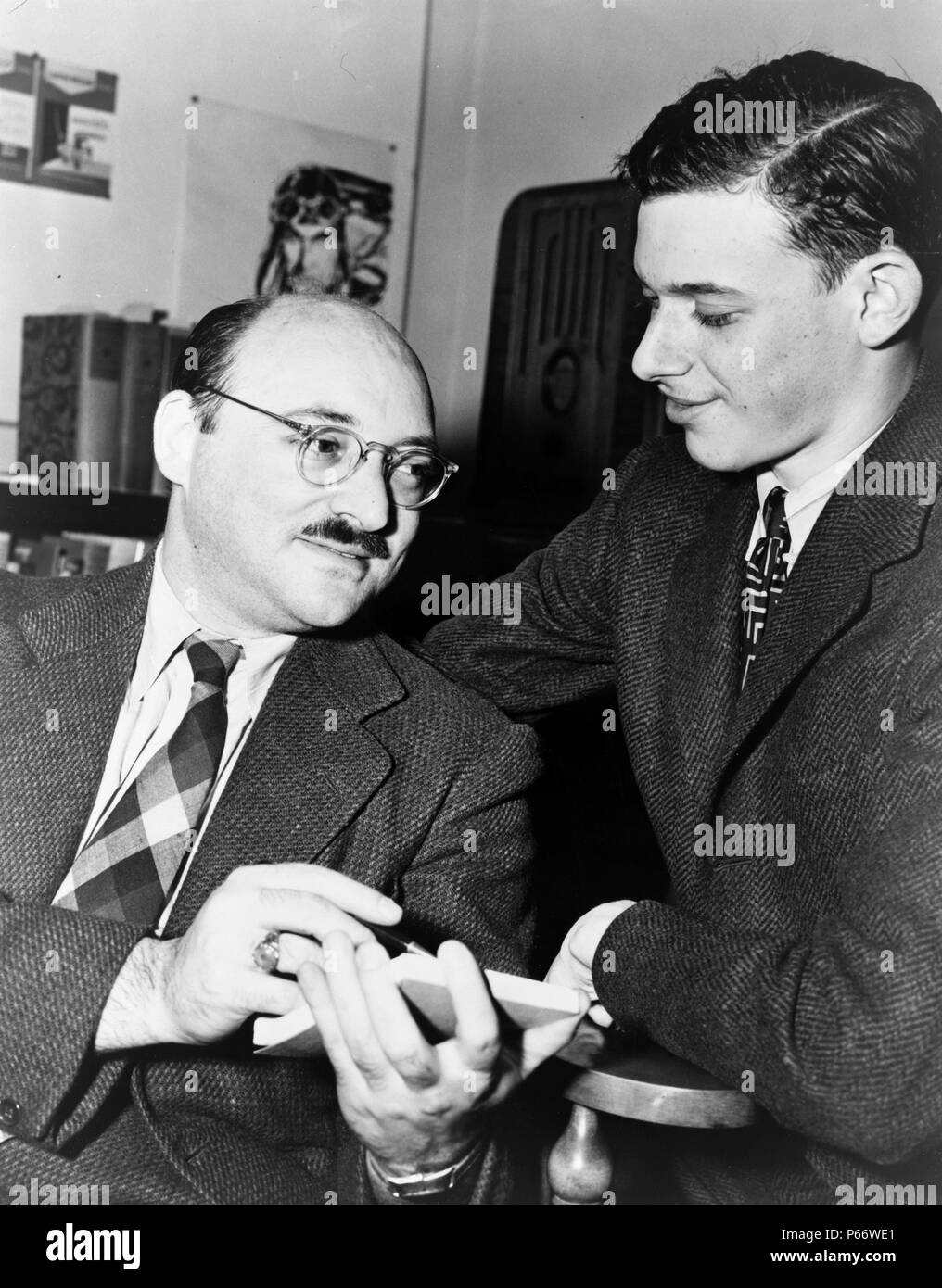 Authors Ellery Queen (left) and James Yaffe. Ellery Queen is both a fictional character and a pseudonym used by two American cousins from Brooklyn, New York—Daniel Nathan, alias Frederic Dannay (October 20, 1905 – September 3, 1982) and Manford (Emanuel) Lepofsky, alias Manfred Bennington Lee (January 11, 1905 – April 3, 1971); to write, edit, and anthologize detective fiction. Stock Photo