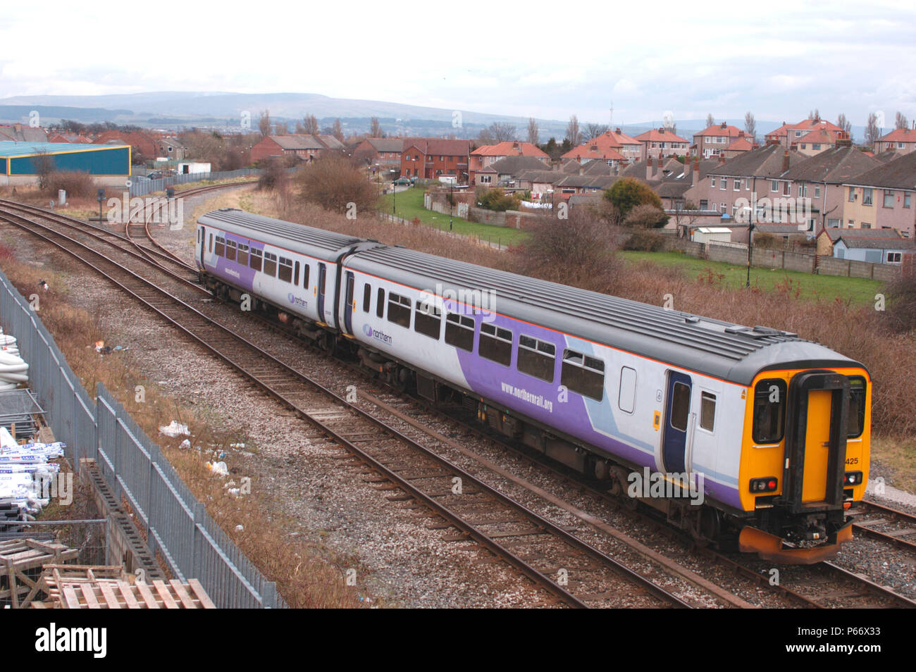 A Class 156 Sprinter DMU trainset, in new Northern Trains lilac livery, approaches Morecambe with a Lancaster - Heysham Port service. March 2005. Stock Photo