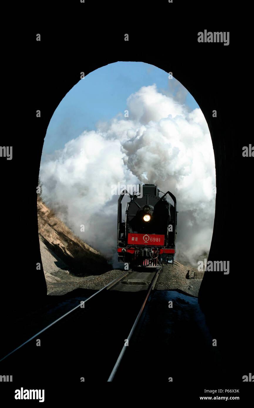 A Daban to Holoku freight having passed the distance signal for Shangdian prepares to enter the summit tunnel, picture dated 2004. Stock Photo