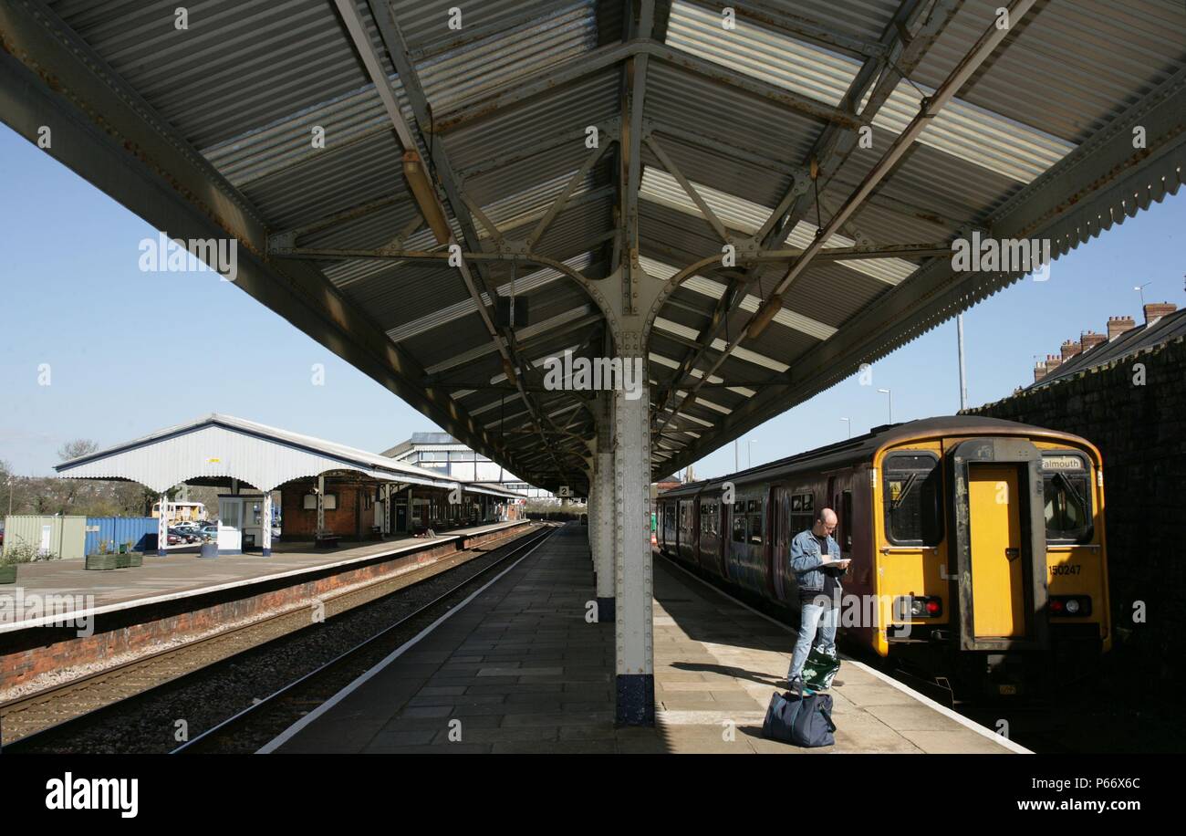 A passenger awaits the departure of the branch line train to Falmouth ...