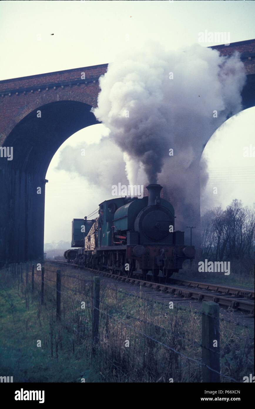 An 0-6-0ST, built by Kitson of Leeds, heads a permanent way train under Oakley Viaduct on the Northamptonshire ironstone system. Stock Photo