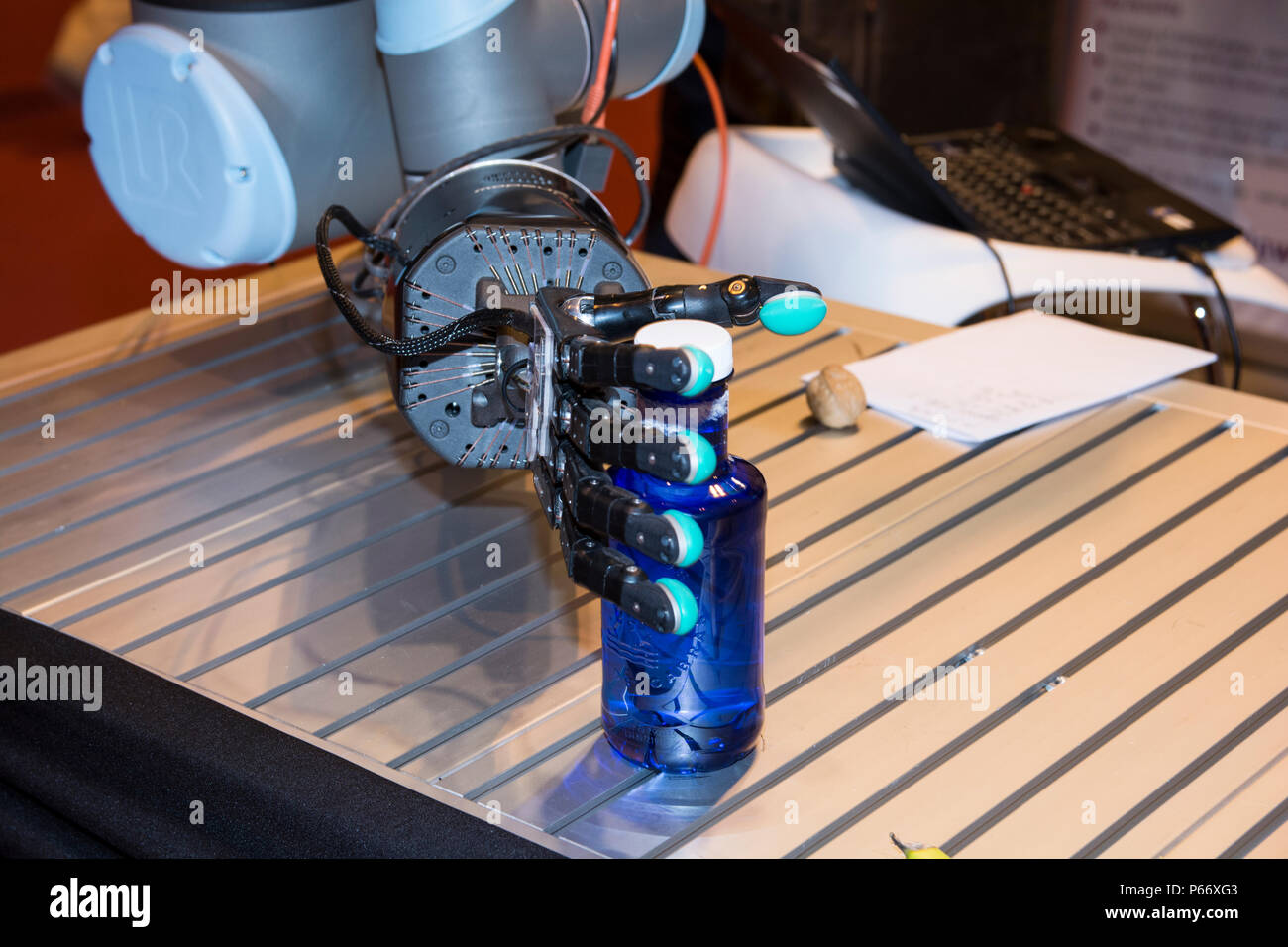 Dexterous hand (robotic sensitive hand) from Shadow Robot Company, holding  with care a blue bottle In GR-EX summit (Global Robot Expo Stock Photo -  Alamy