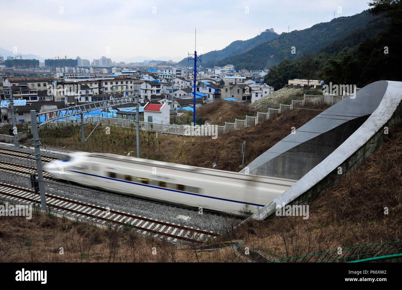 CRH 2 class electric multiple unit passes the western suburbs of Wenzhou on its way to Ningbo and Shanghai on the Ningbo - Wenzhou - Fuzhou High Speed Stock Photo