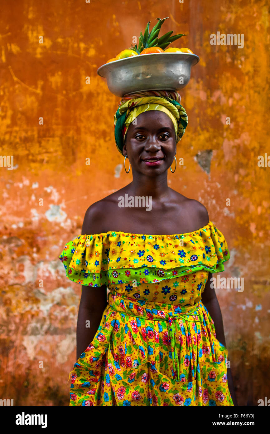An Afro-Colombian girl, dressed in the traditional ‘palenquera’ costume, poses for a picture in Cartagena, Colombia. Stock Photo