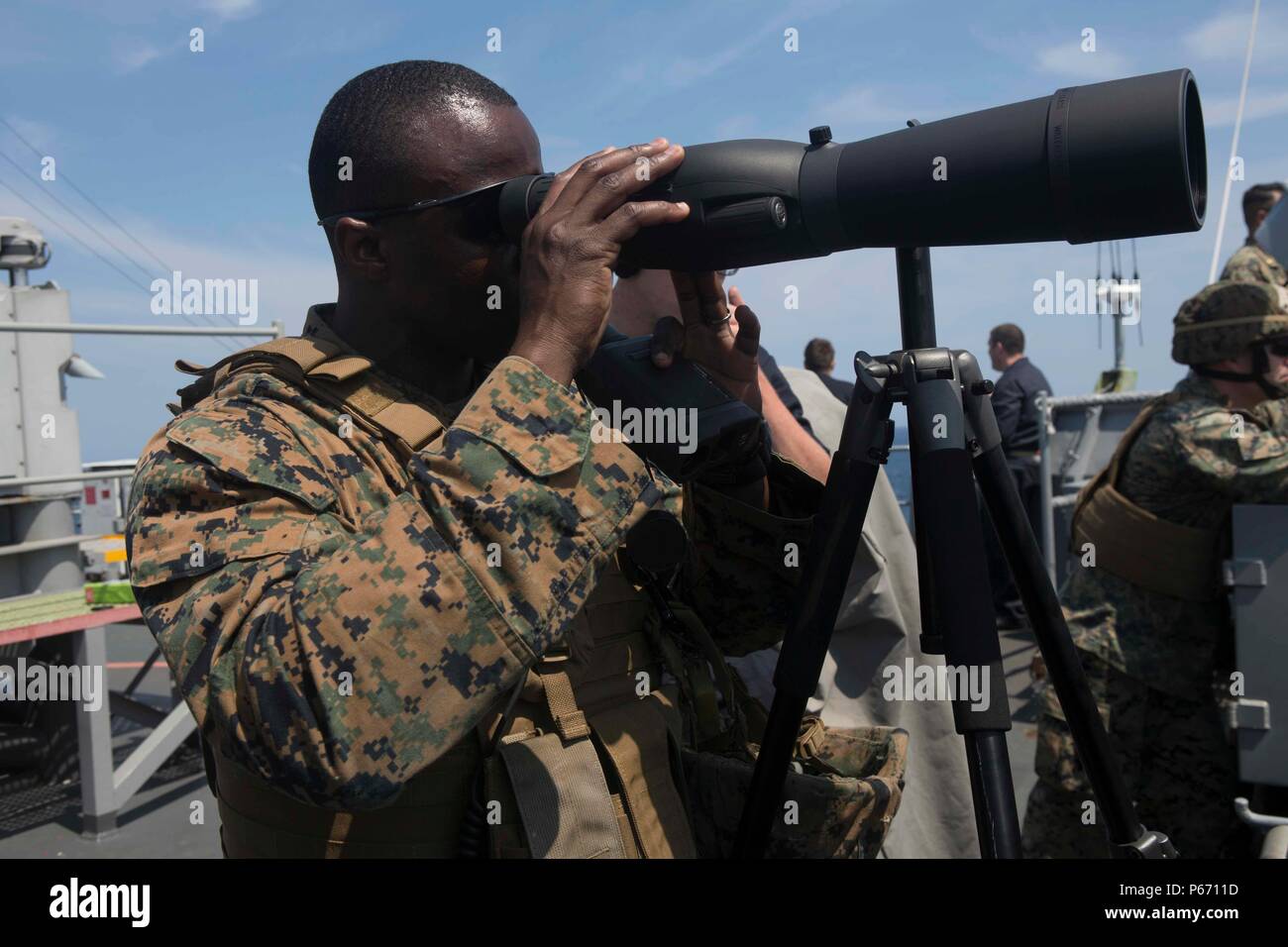 U.S. Marine Corps Staff Sgt. Christopher J. Gilchrist, an engineer assigned  to Combat Logistics Battalion 22, 22nd Marine Expeditionary Unit, uses a spotting  scope in a Small Caliber Action Team (SCAT) training