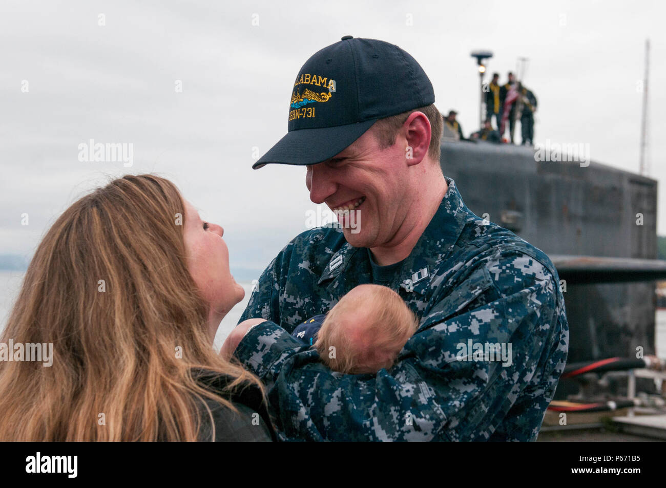 BANGOR, Wash. (May 14, 2016) – Lt. Tim Markley, from Mohnton, Pennsylvania, assigned to the Blue crew of the Ohio-class ballistic-missile submarine USS Alabama (SSBN 731), meets his newborn baby for the first time, as the boat returns to Naval Base Kitsap-Bangor following a routine strategic deterrent patrol. Alabama is one of eight ballistic-missile submarines stationed at the base providing the most survivable leg of the strategic deterrence triad for the United States. (U.S. Navy photo by Mass Communication Specialist 2nd Class Amanda R. Gray/Released) Stock Photo
