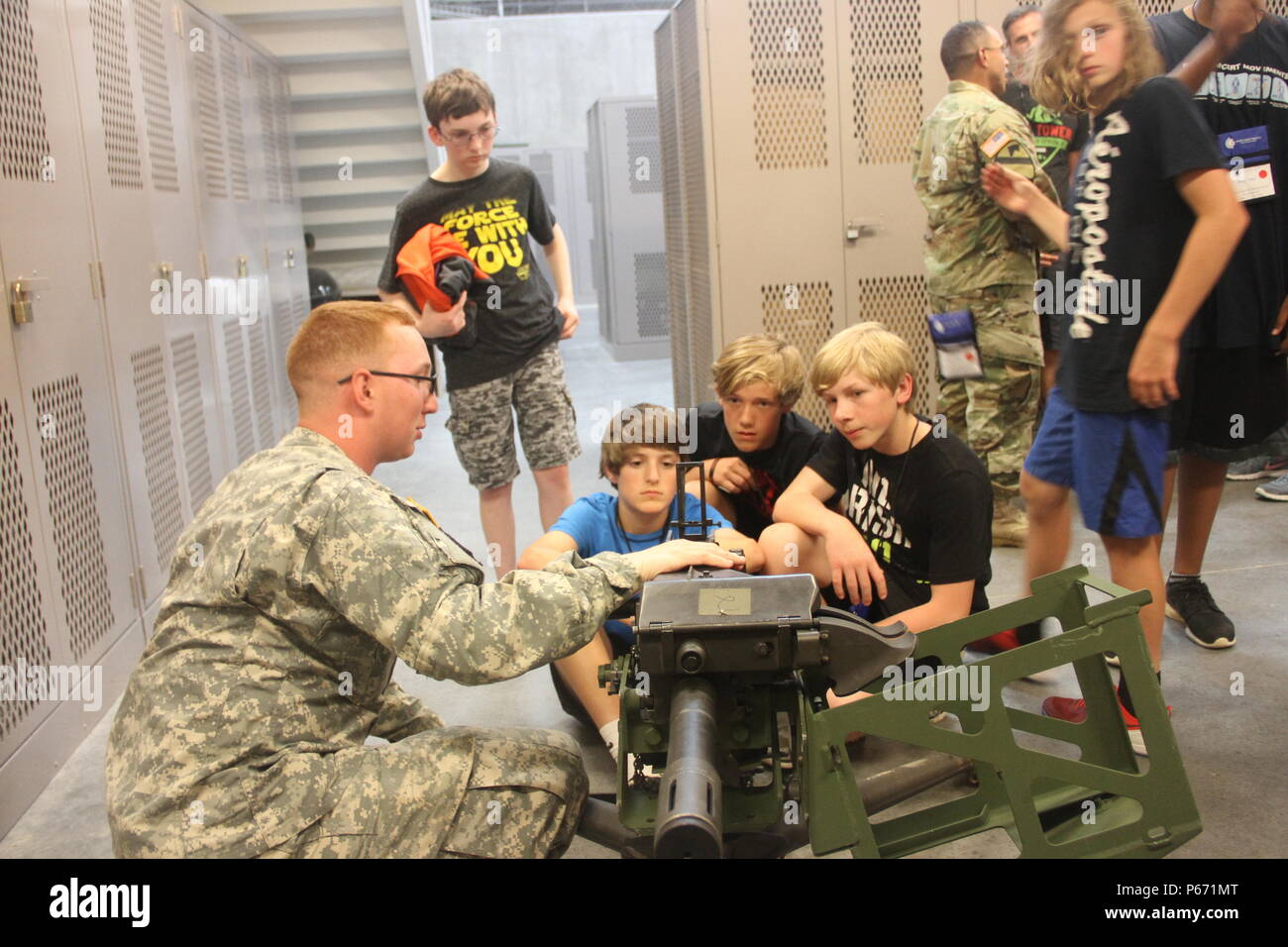 Spc. Jeffery Hicks, a joint nodal network specialist with Company C, 9th Brigade Engineer Battalion, 2nd Infantry Brigade Combat Team, 3rd Infantry Division, explains how to aim an Mk 19 grenade launcher to Ralph Chandler Middle School students at Fort Stewart, Ga., May 11, 2016. 9th BEB provided the school group a tour as part of Fort Stewart and 3rd Infantry Division’s community outreach program. (U.S. Army photo by Spc. Nicholas Holmes/ Released) Stock Photo