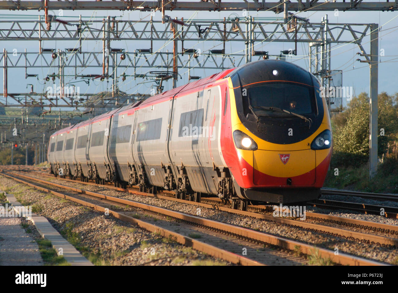 A Pendolino races south across the Cheshire Plain whilst working a Manchester Piccadfilly - Euston service diverted from its normal route by engineeri Stock Photo