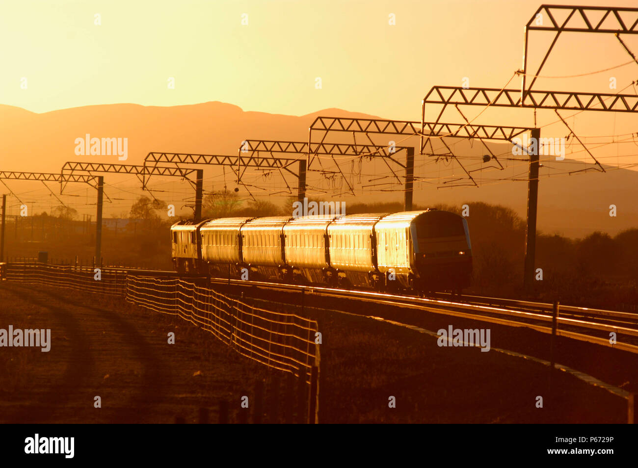 A ScotRail service headed by DVT 82112 catches the late afternoon sun as it leads an Edinburgh to North Berwick local service into Prestonpans. Novemb Stock Photo