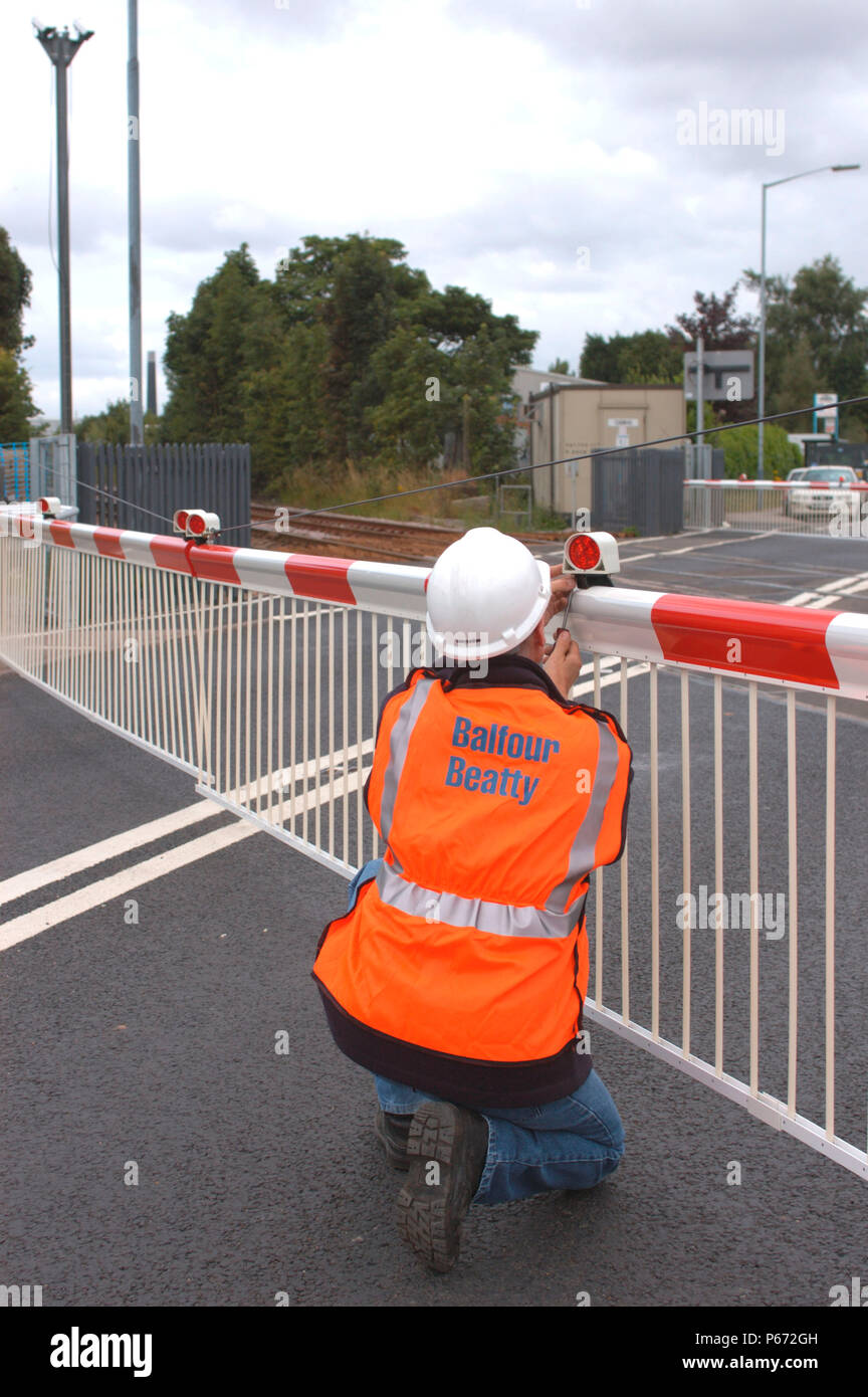 A technician checks the light on the barrier at an automatic level crossing. July 2005. Stock Photo