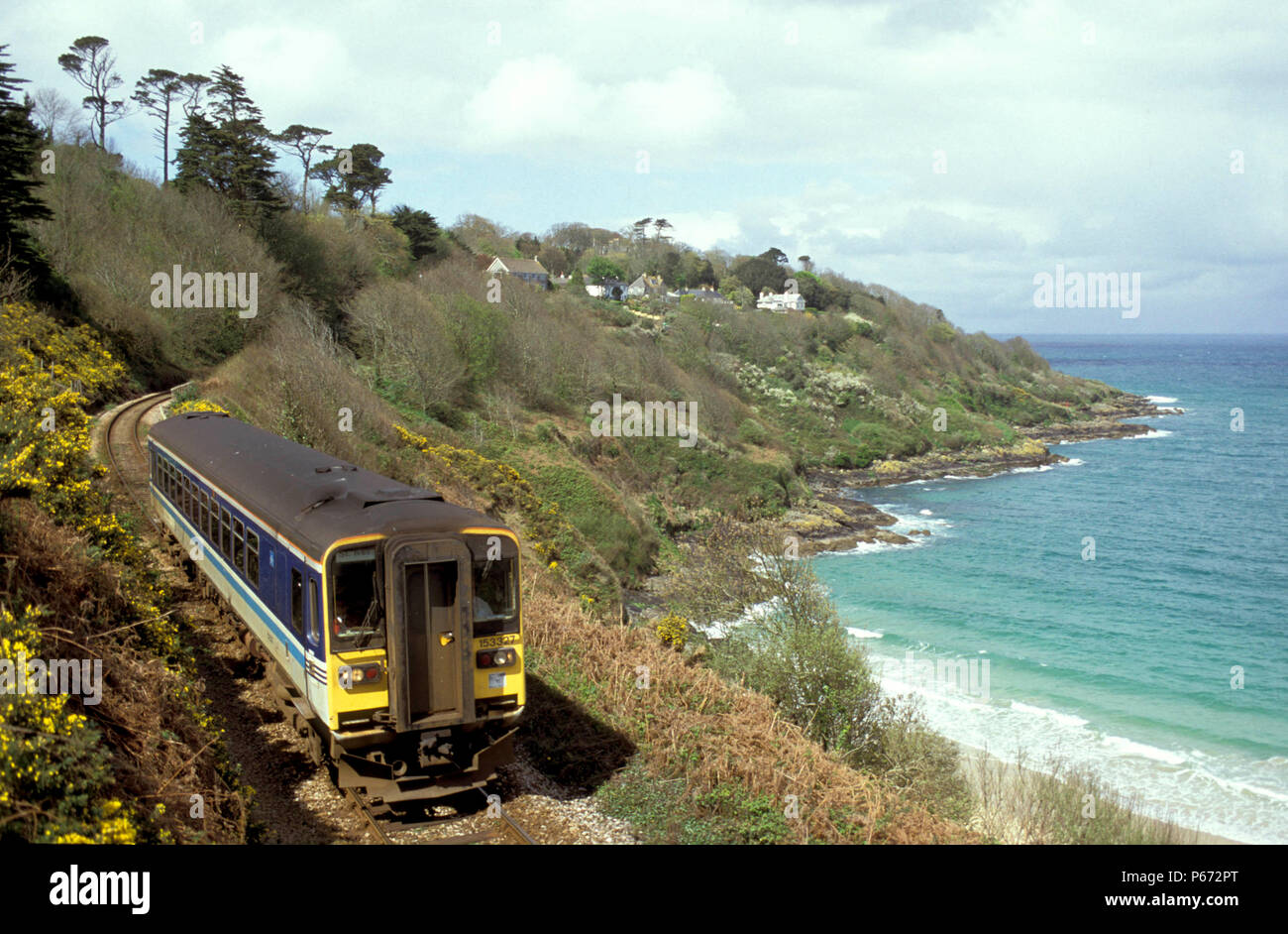A Wessex Trains Class 153 traverses the coastal section of the St. Erth to St. Ives branch line near Lelant in Cornwall with a service to Penzance. c2 Stock Photo
