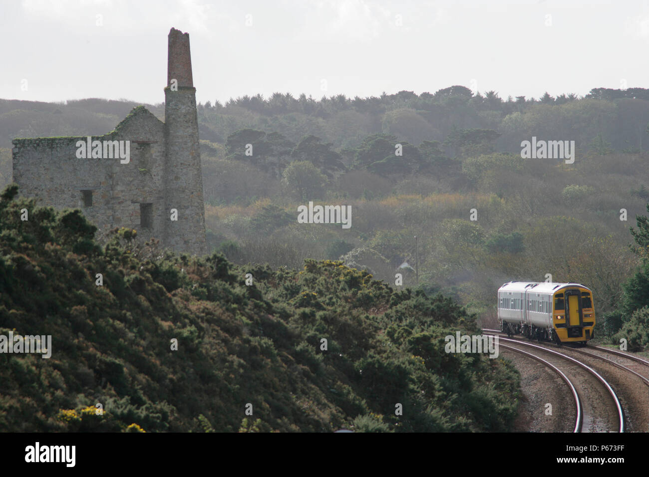 A Wessex Trains service passes the disused tin mine at Scorrier in rural Cornwall with a train from Penzance. November 2005 Stock Photo