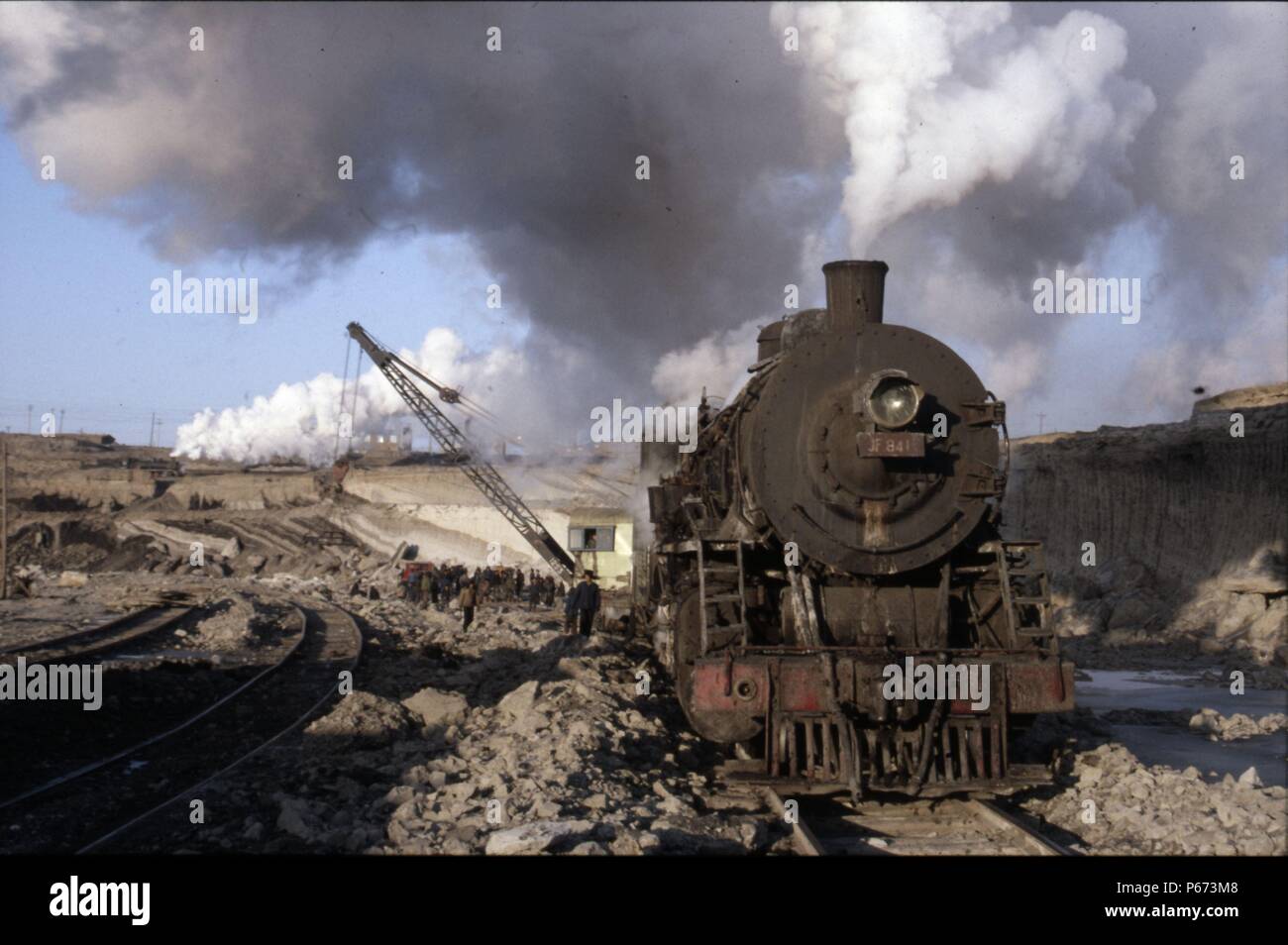 An American inspired JF Class Mikado 2-8-2 heads a track slewing engineer's train in the vast opencast coalmine at Manzhouli on China's Russian border Stock Photo