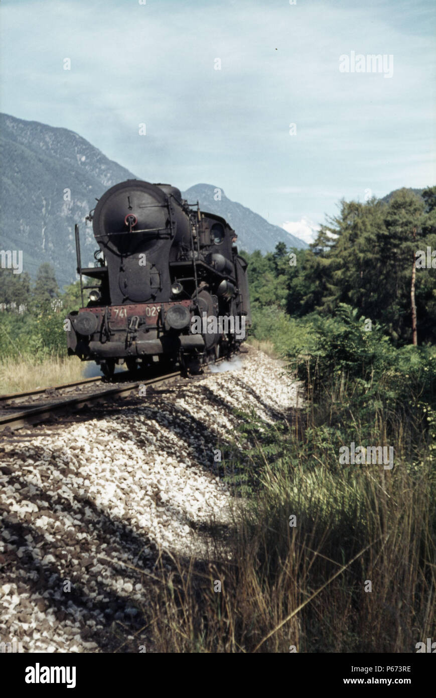 An Italian Railways Crosti boilered 741 Class 2-8-0 heads a Fortezza to San Candido train through the Dolomite mountains on Sunday 29th August 1971. Stock Photo