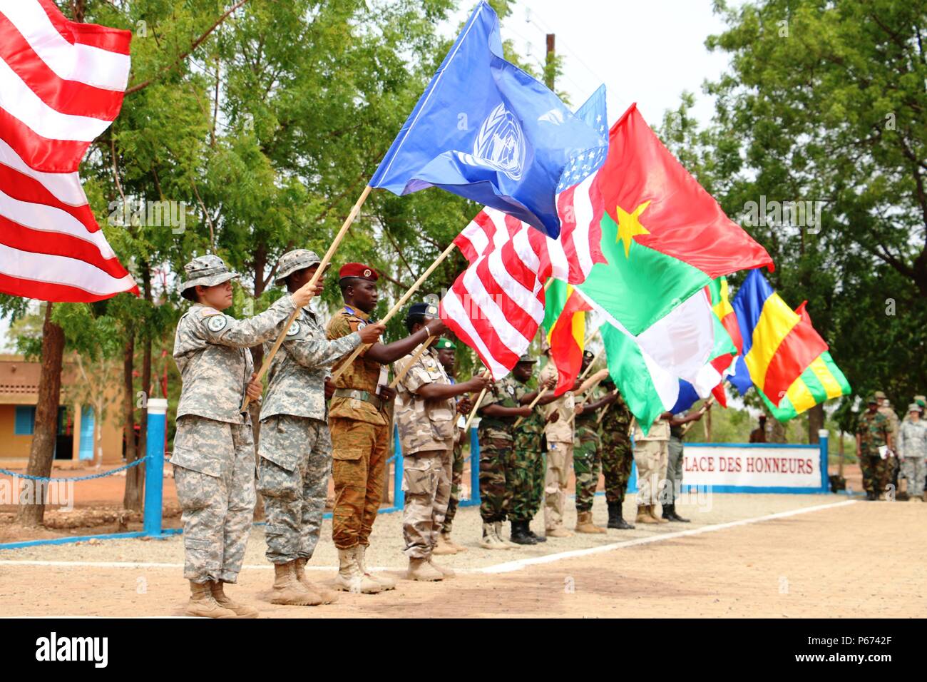 Multinational Western Accord 2016 participants display flags for each country represented at the exercise’s Closing Day Ceremony May 13, 2016 at Camp Zagre, Ouagadougou, Burkina Faso. The two-week command post exercise, which began May 2, brought together 15 West African Nations, 7 NATO European countries and the U.S. to work as a multinational headquarters to build interoperability and shared understanding. (U.S. Army photo by Staff Sgt. Candace Mundt/Released) Stock Photo