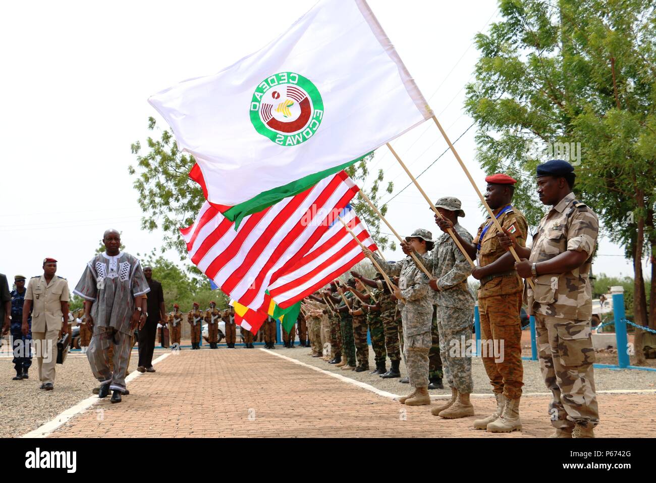 Burkina Faso Prime Minister Paul Kaba Thieba walks past the flags of multinational partners during the Western Accord 2016 Closing Day Ceremony May 13, 2016 at Camp Zagre, Ouagadougou, Burkina Faso. The two-week command post exercise, which began May 2, brought together 15 West African Nations, 7 NATO European countries and the U.S. to work as a multinational headquarters to build interoperability and shared understanding. (U.S. Army photo by Staff Sgt. Candace Mundt/Released) Stock Photo