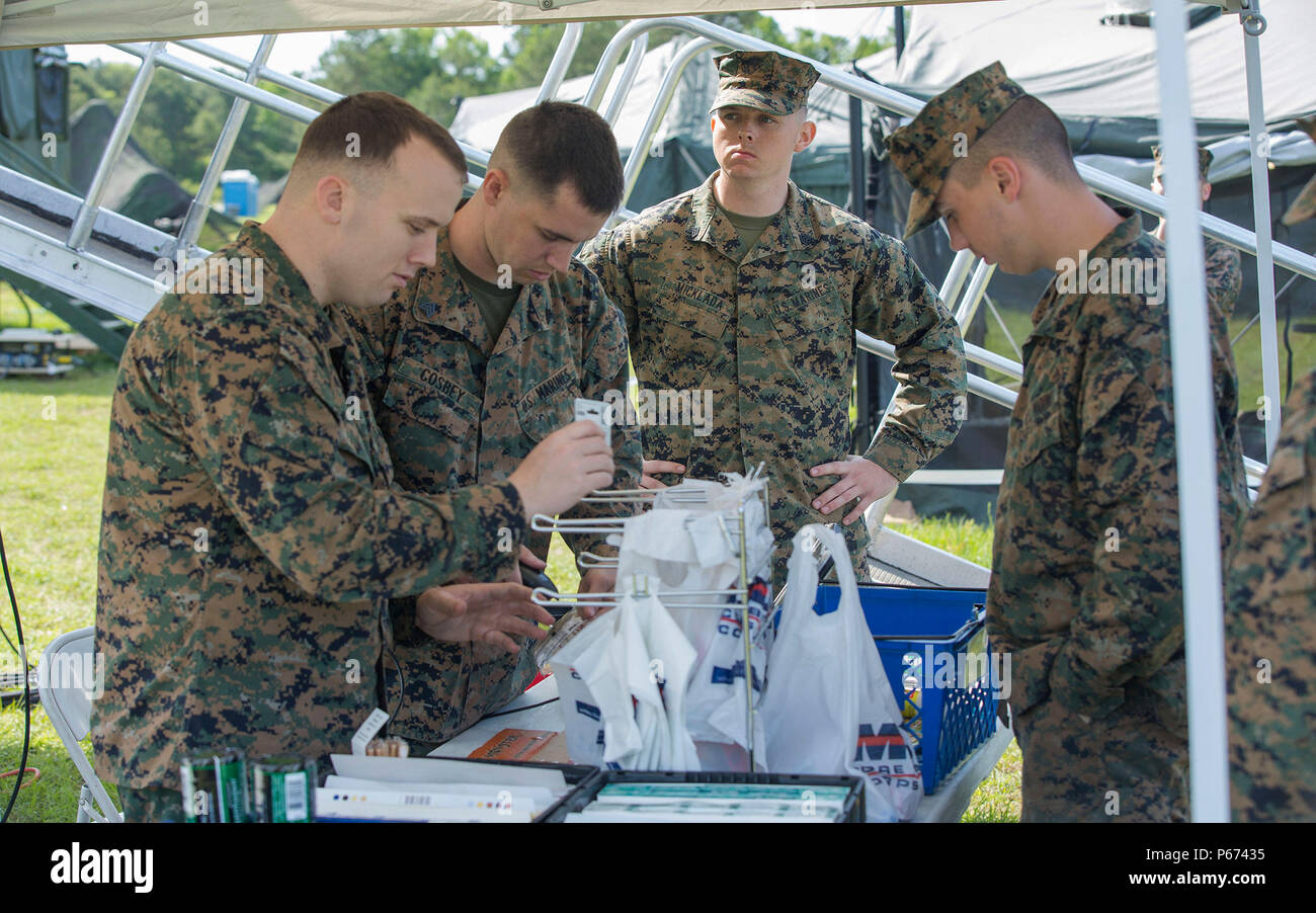 U.S. Marines with Headquarters Support Battalion sell goods to service members utilizing a mobile exchange during the II Marine Expeditionary Force Exercise 2016 (MEFEX) at Landing Zone Albatross on Camp Lejeune, N.C., May 16, 2016.  Service members participated in MEFEX 2016 in order to build 2nd MLG's warfighting capability and its ability to function as the II MEF Logistics Command Element. (U.S. Marine Corps photo by Lance Cpl. Tyler W. Stewart/Released) Stock Photo