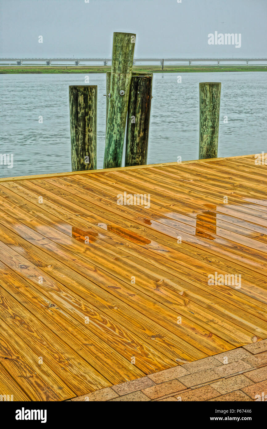 Chincoteague Island, Virginia, USA: Boardwalk along Robert Reed Downtown Park in Chincoteague, with the causeway to the mainland in the background. Stock Photo