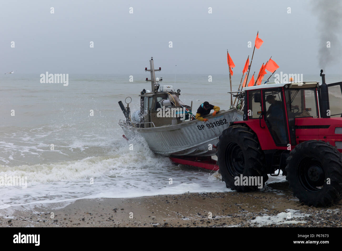 Tractor launching fishing boat, Normandy, France Stock Photo