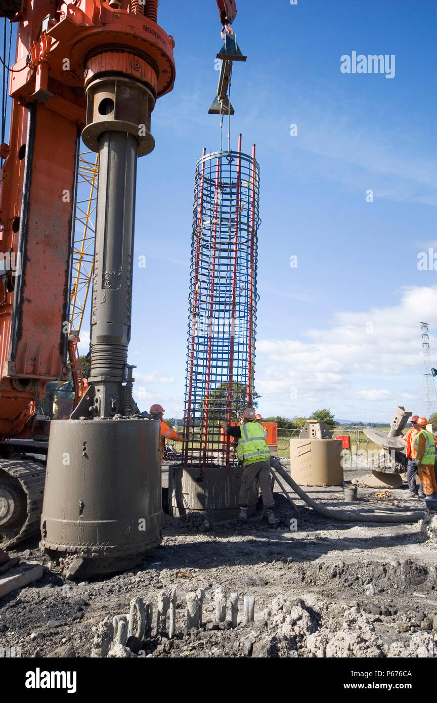 Construction crew at work fitting reinforcing into the piling Stock