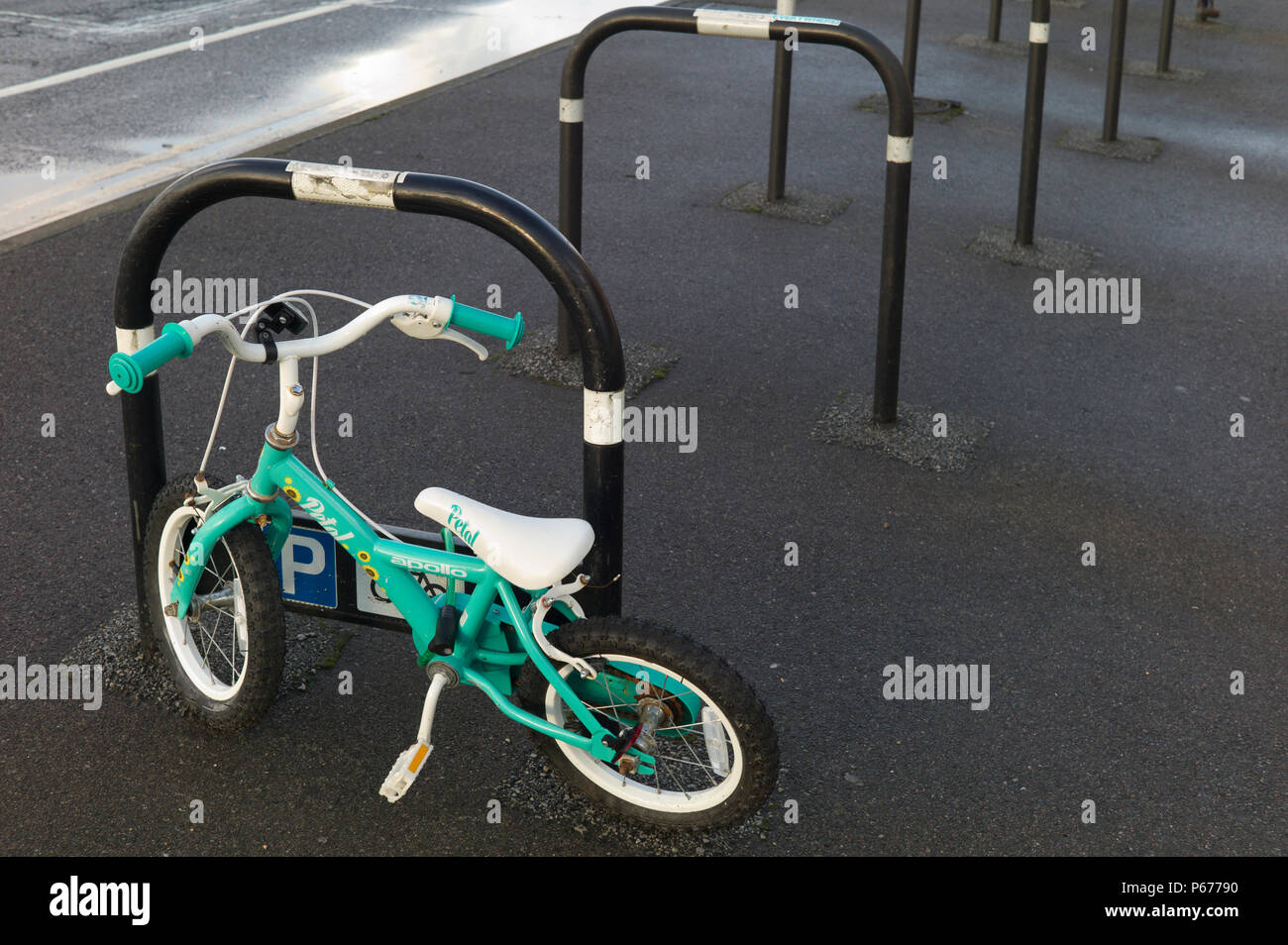 Child's green bicycle at empty bike park Stock Photo