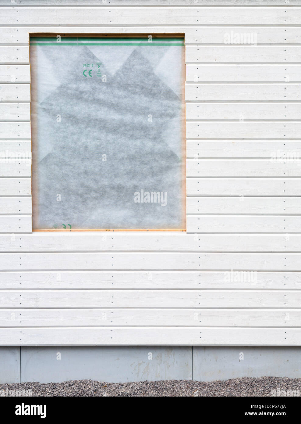 Window opening on wooden facade Stock Photo