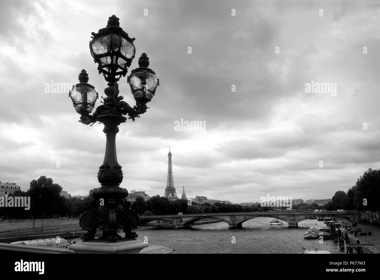 View from Pont Alexandre III towards the Eiffel Tower, Pont des Invalides and the Seine below. Stock Photo