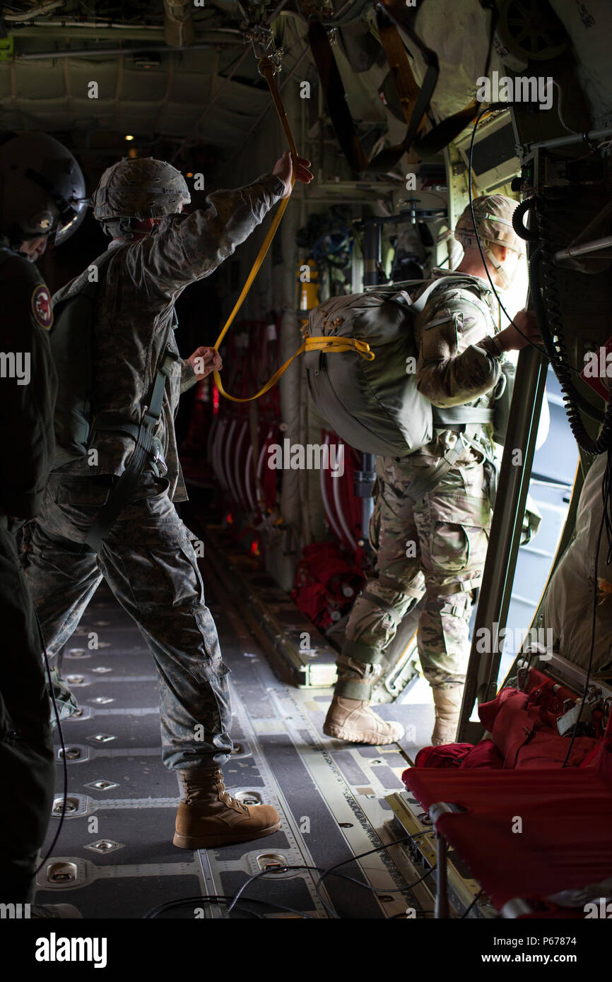 A U.S. Army jumpmaster prepares to exit a C-130 Hercules in a