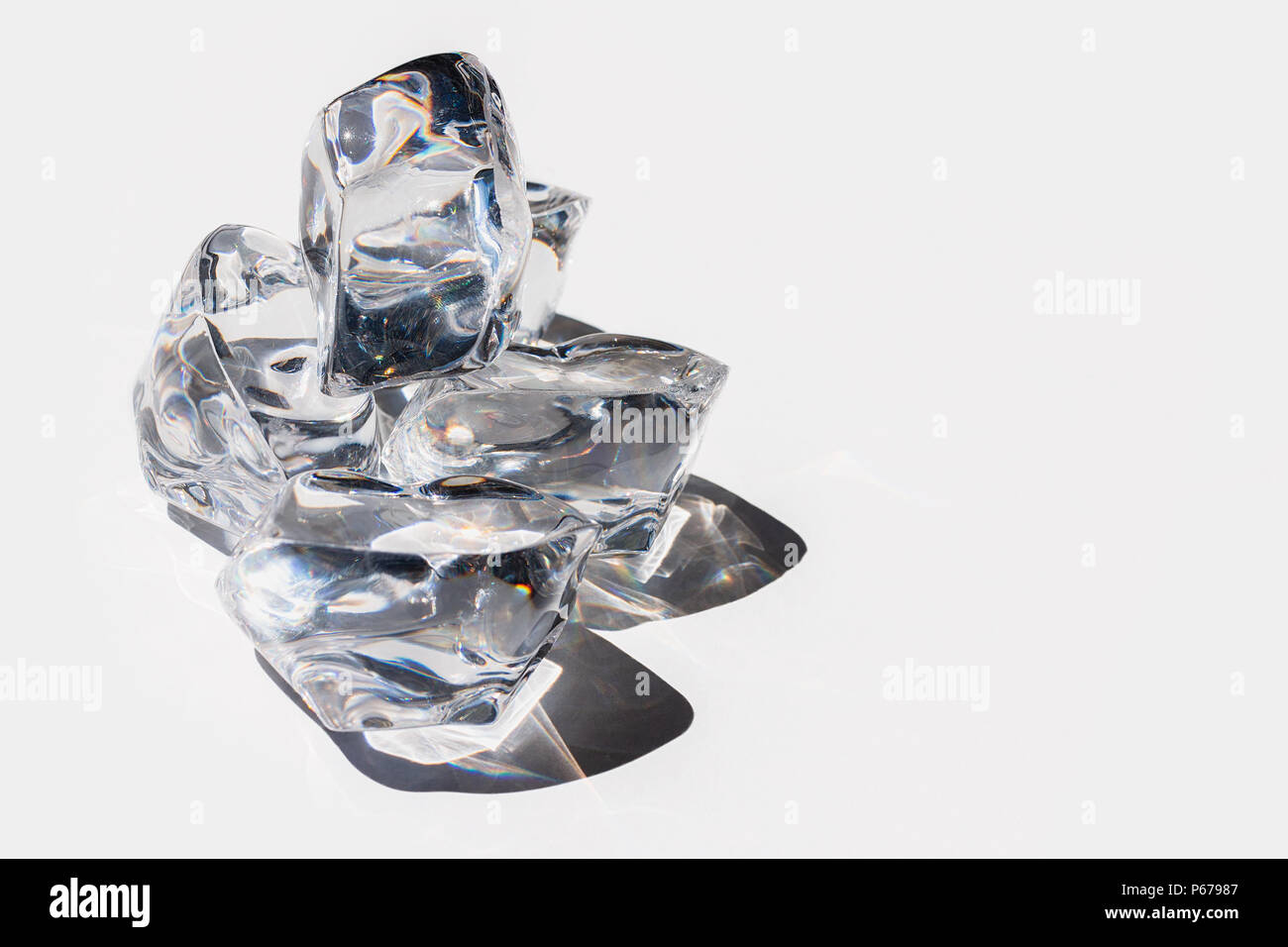 Crystal looking ice cubes on a white background Stock Photo - Alamy
