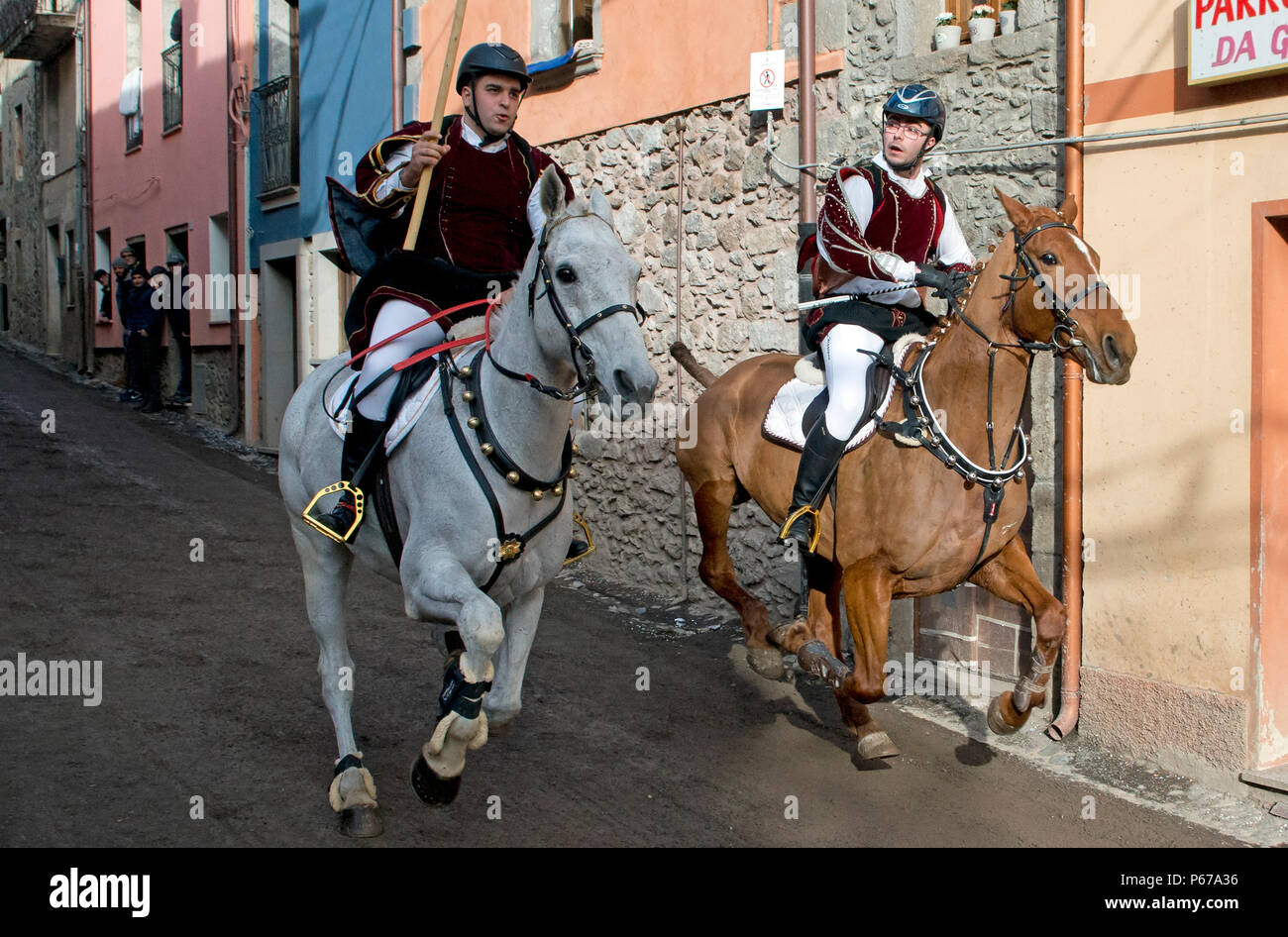 Couple ride reckless horserace 'Sa Carrela e Nanti', during the carnival at Santu Lussurgiu, Oristano, Sardinia, Italy, Europe Stock Photo
