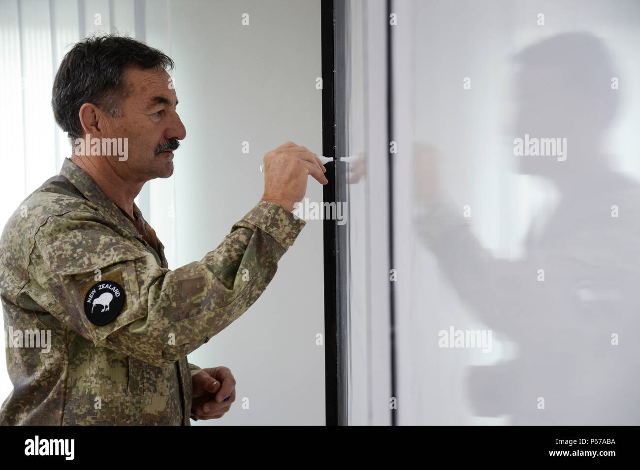 160525-N-GI544-091 PANCHKHAL, Nepal (May 25, 2016) – Maj. Jim Josephs, assigned to J5-H Joint Operational Health Group, New Zealand Defense Force, writes and presents information during a seminar on force health protection in peacekeeping operations between the U.S., New Zealand, Nepalese and Bangladeshi military medical professionals at the Birendra Peace Operations Training Center in Panchkhal, Nepal. The seminar was formed to enhance force medicine practices within the U.S. military as well as share and collaborate with partner nations across the Indo-Asia-Pacific region. (U.S. Navy photo Stock Photo