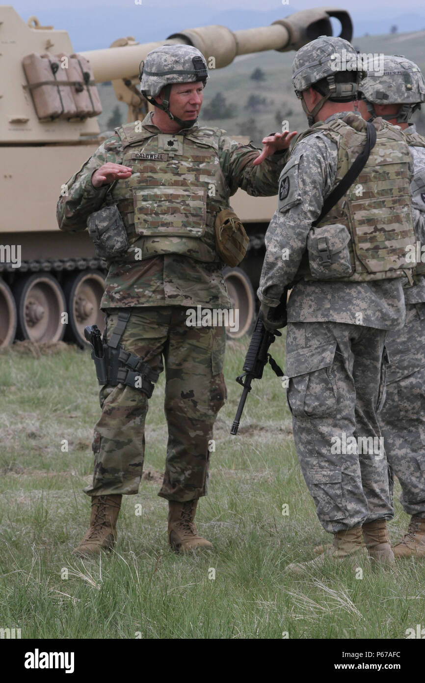 Lt. Col. Christopher Caldwell, commander of 2nd Battalion, 222nd Field Artillery Regiment, 65th FA Brigade, Utah Army National Guard, talks to battery level leaders at the direct fire range on Camp Guernsey, Wyo., May 14, 2016, during Operation Gunsmoke 16. Operation Gunsmoke is the 65th Field Artillery Brigade live-fire exercise consisting of 1,300 Soldiers from six states, conducting operations in Camp Guernsey for annual training 2016. (U.S. Army photo by Sgt. 1st Class Whitney Houston, 128th MPAD) Stock Photo