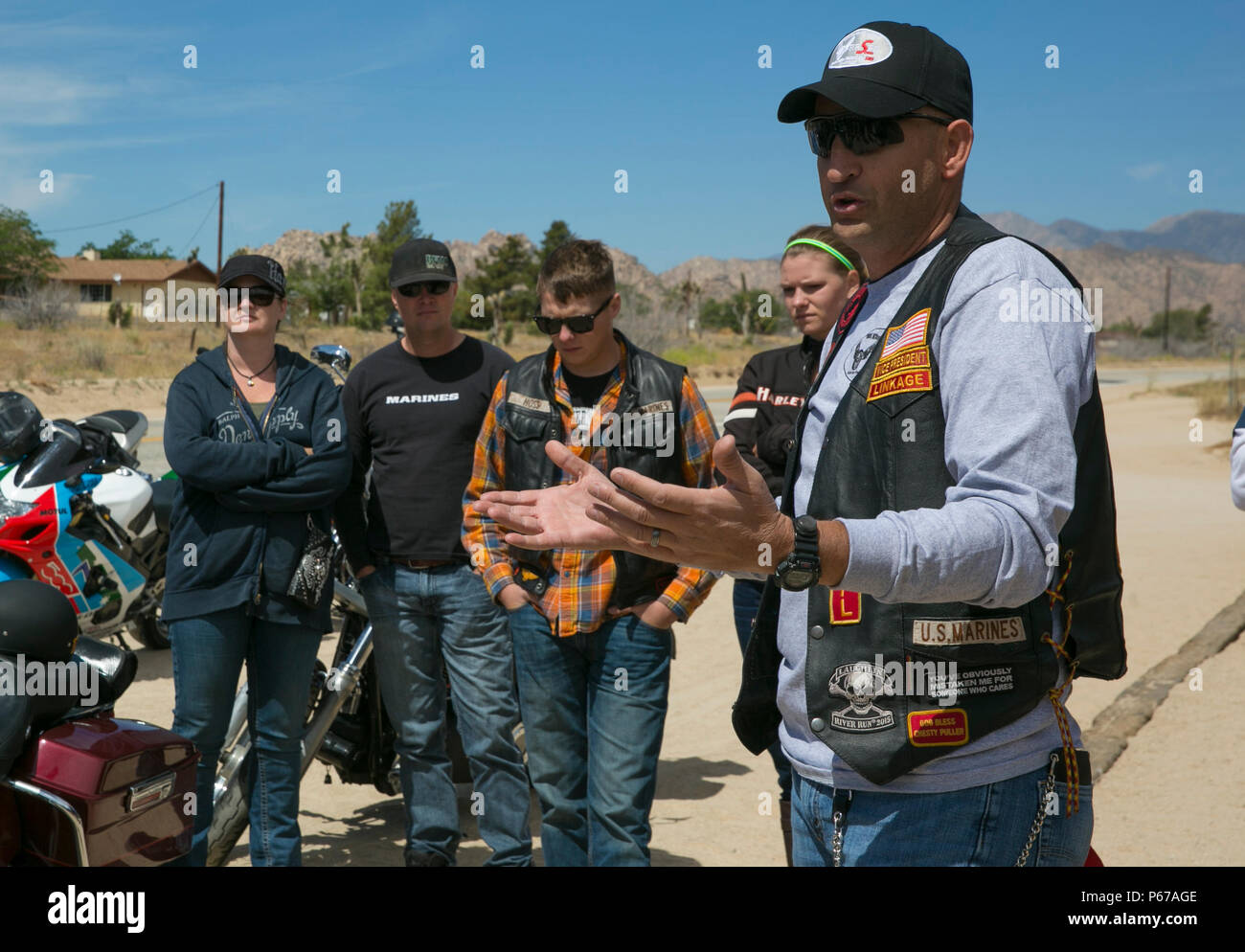 Master Sgt. Frank Edling, operations chief, 3rd Assault Amphibian Battalion, talks to fellow motorcycle riders outside of Pappy and Harriet’s in Yucca Valley, Calif., during the Substance Abuse Program’s Freedom to Ride, Ride for Freedom Sober Motorcycle Ride May 20, 2016. More than 40 motorcycle riders, including Marines and sailors, veterans and community members, attended the event to raise awareness of the dangers of substance abuse. (Official Marine Corps photo by Lance Cpl. Dave Flores/Released) Stock Photo