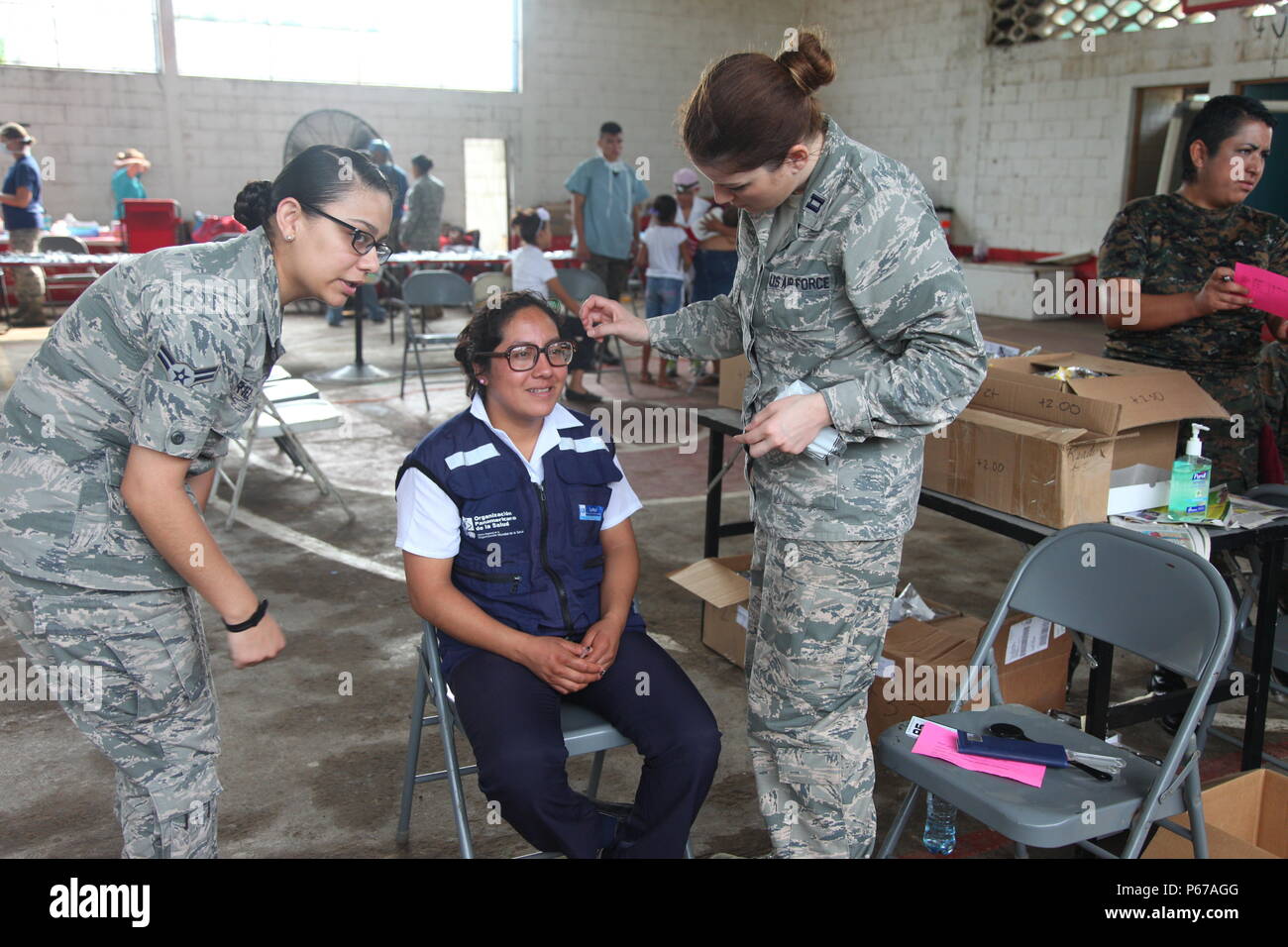U.S. Air Force Airman Cpt. Amanda Duty and Airman 1st Class Georgina Cortez,  with the 42nd Medical Group, fit Guatemalan citizen with new glasses, in La  Blanca, Guatemala, May 24, 2016. Task