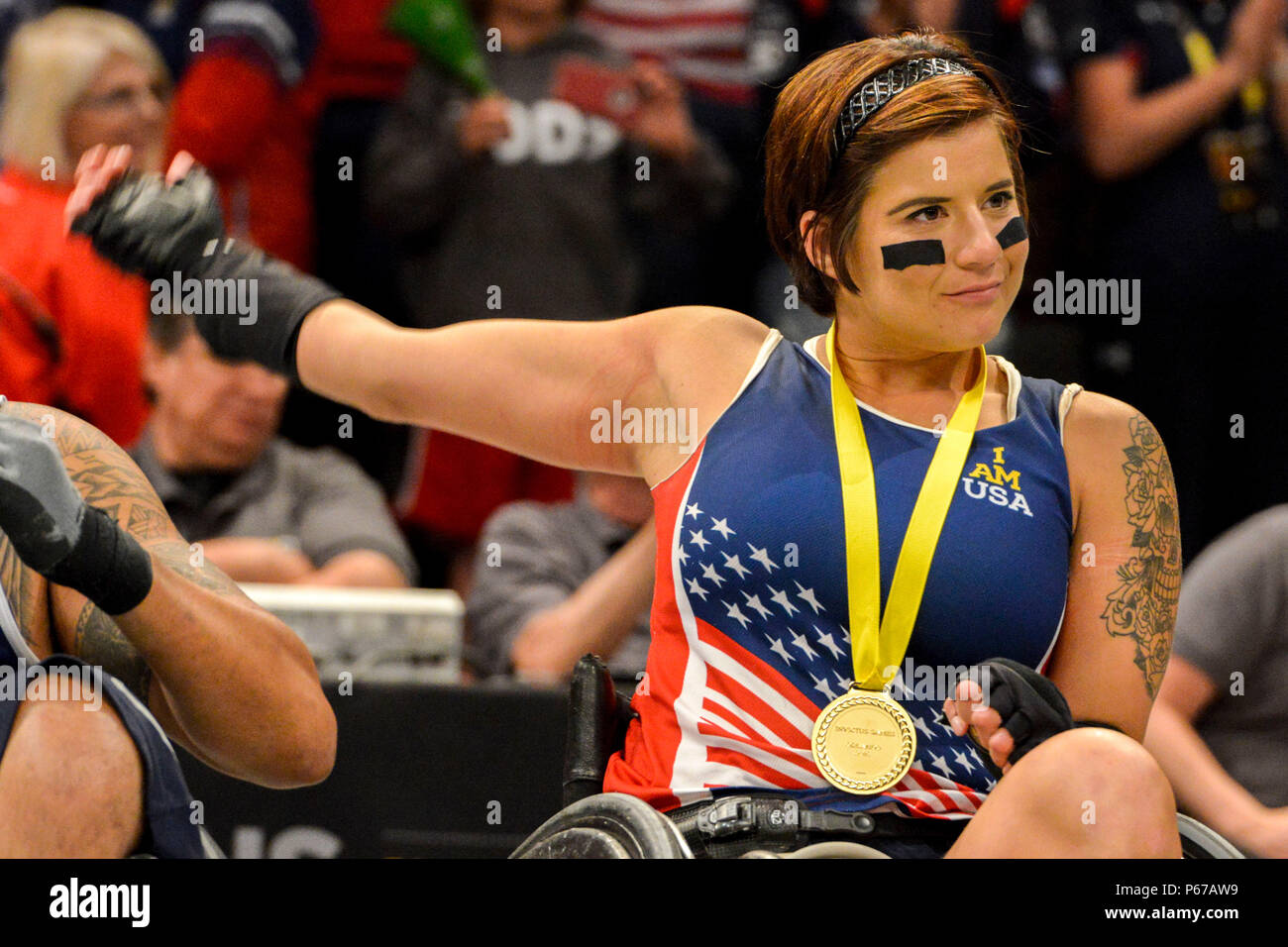 160511-F-WU507-108: Air Force Staff Sgt. Sebastiana Lopez-Arellano, Team US, stretches and smiles after U.S. Vice President Joe Biden presents her a gold metal, for winning the US versus Denmark wheel chair basketball gold metal match at the 2016 Invictus Games, at the ESPN Wide World of Sports complex at Walt Disney World, Orlando, Fla., May 11, 2016. The US beat Denmark 28-19, and took gold; Denmark took silver and the bronze went to the UK, who beat Australia 47-4. (U.S. Air Force photo by Senior Master Sgt. Kevin Wallace/RELEASED) Stock Photo