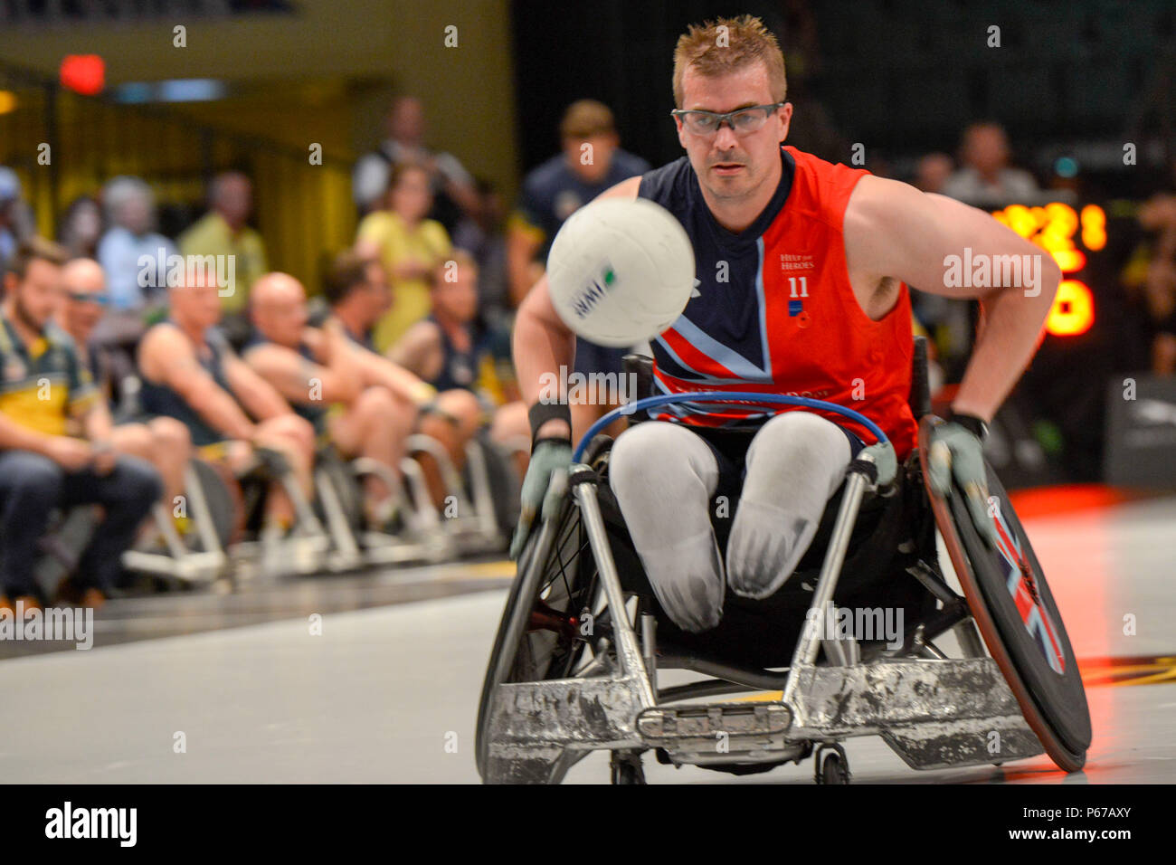 160511-F-WU507-150: The Team UK captain rushes the ball down the court during the UK versus Australia wheel chair basketball bronze metal match at the 2016 Invictus Games, at the ESPN Wide World of Sports complex at Walt Disney World, Orlando, Fla., May 11, 2016. The UK beat Australia 47-4 to take bronze; the US beat Denmark 28-19, and took gold; Denmark took silver. (U.S. Air Force photo by Senior Master Sgt. Kevin Wallace/RELEASED) Stock Photo