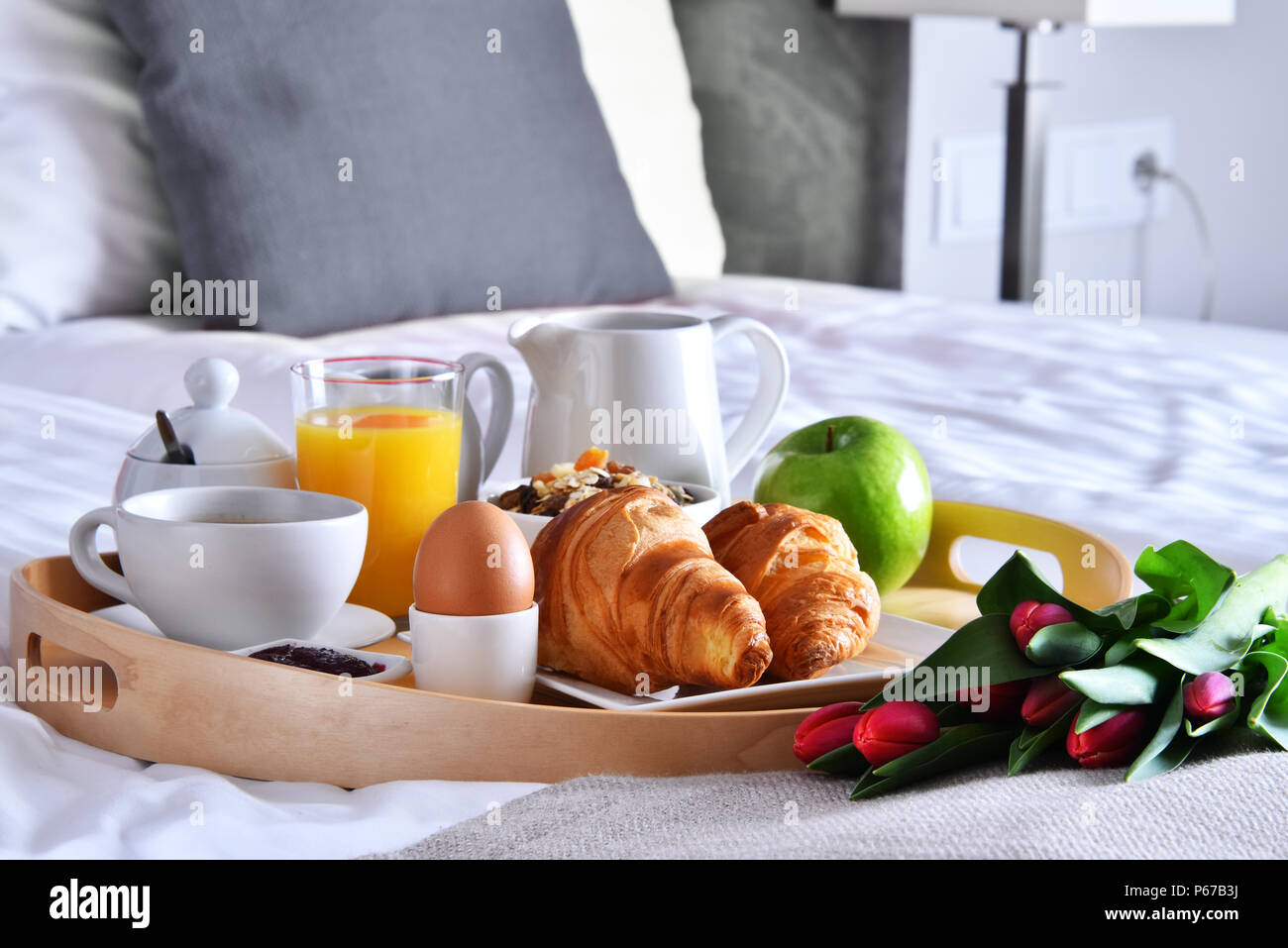 Breakfast on tray in bed in hotel room Stock Photo Alamy