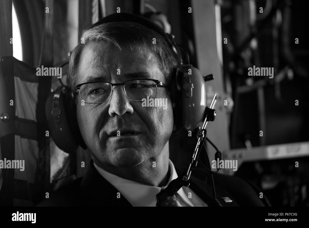 Secretary of Defense Ash Carter listens to radio traffic on a CH-47 Chinook as he flies to the Air Force Academy after visiting the Joint Interagency Combined Space Operations Center at Shriever Air Force Base, Colo., May 12, 2016 . (Photo by Senior Master Sgt. Adrian Cadiz)(Released) Stock Photo