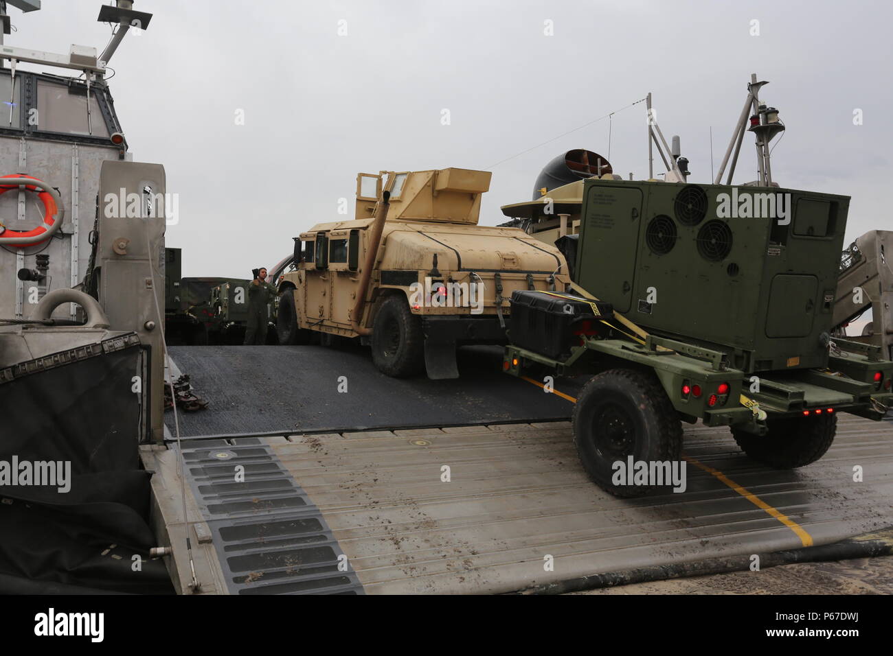 Lcac Loading A U.S. Navy Sailor from Assault Craft Unit 4 guides a U.S. Marine Corps ...