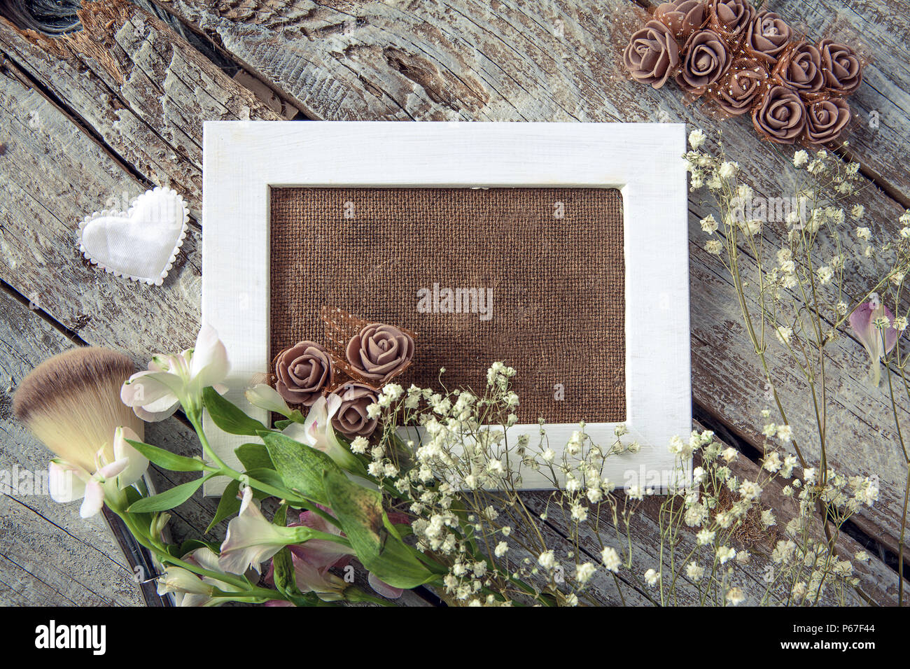 Blank photo frame and white flowers over wooden table background Stock ...