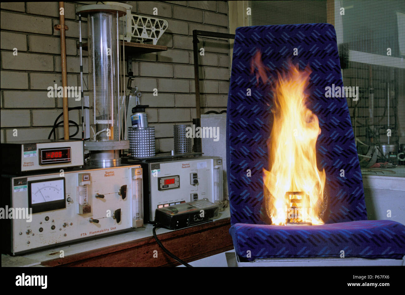Flamability testing of seat covering fabric. C 1993 Stock Photo