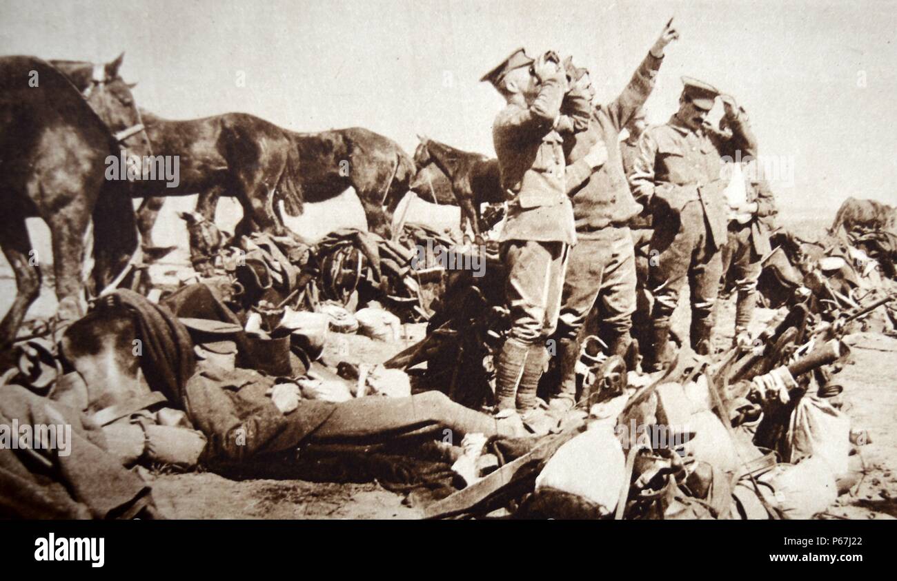 British and French soldiers spot a German plane flying above them. World War One 1917 Stock Photo