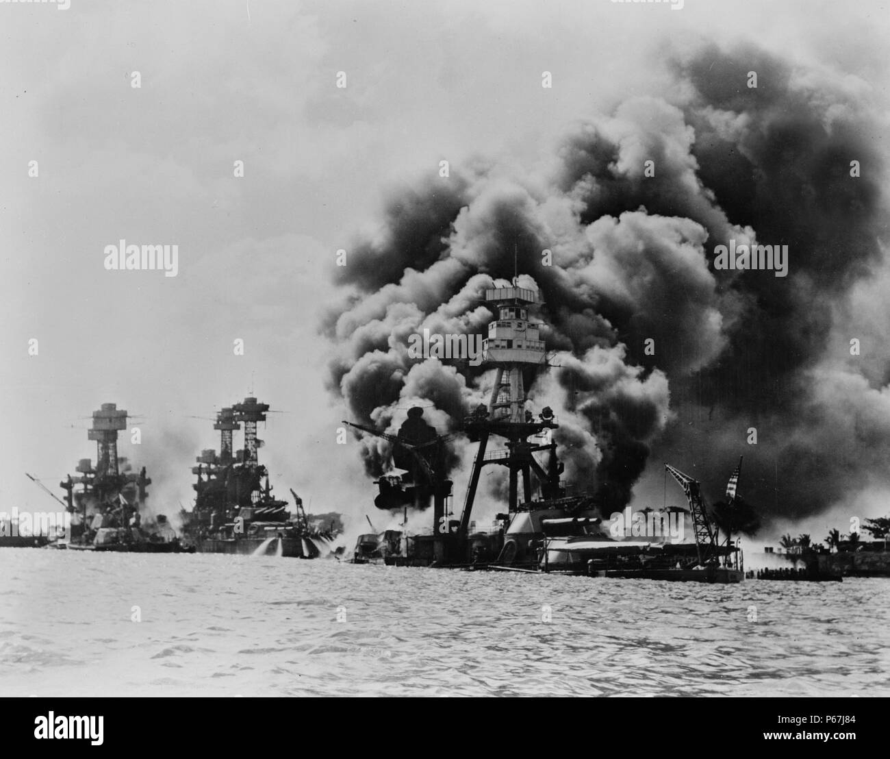 three stricken US battleships Left to right  West Virginia;   Tennessee;   Arizona after the Japanese attack on Pearl Harbour;   in World War II 1941 Stock Photo