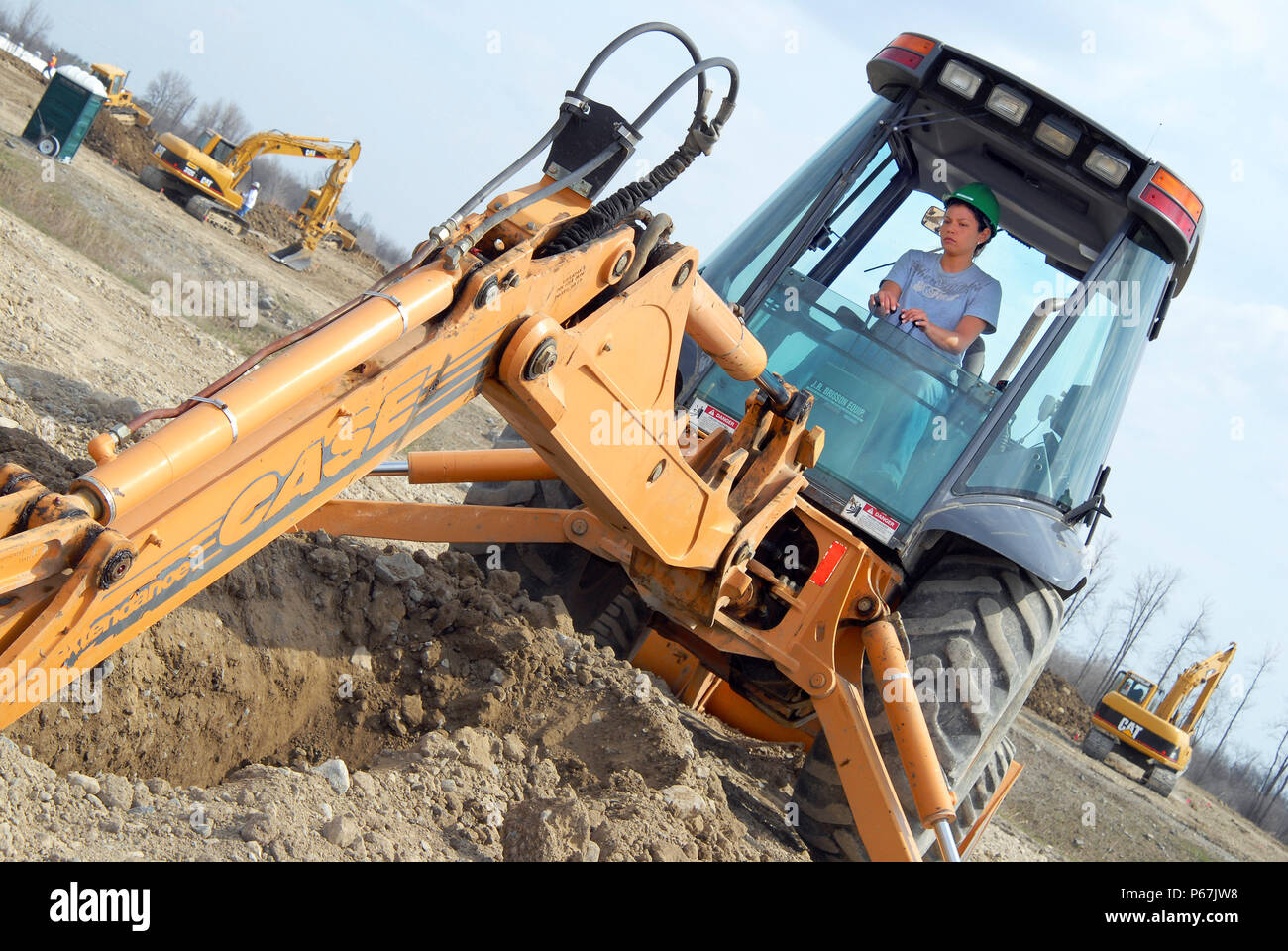 Woman operating backhoe excavator at training facility, Prescott, Ontario, Canada Stock Photo