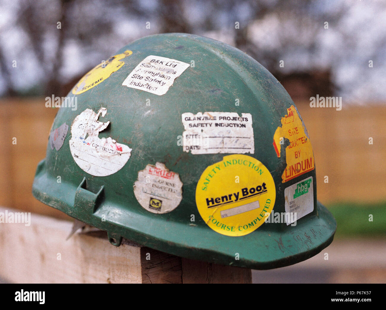 Worn hard hat covered in stickers Stock Photo Alamy