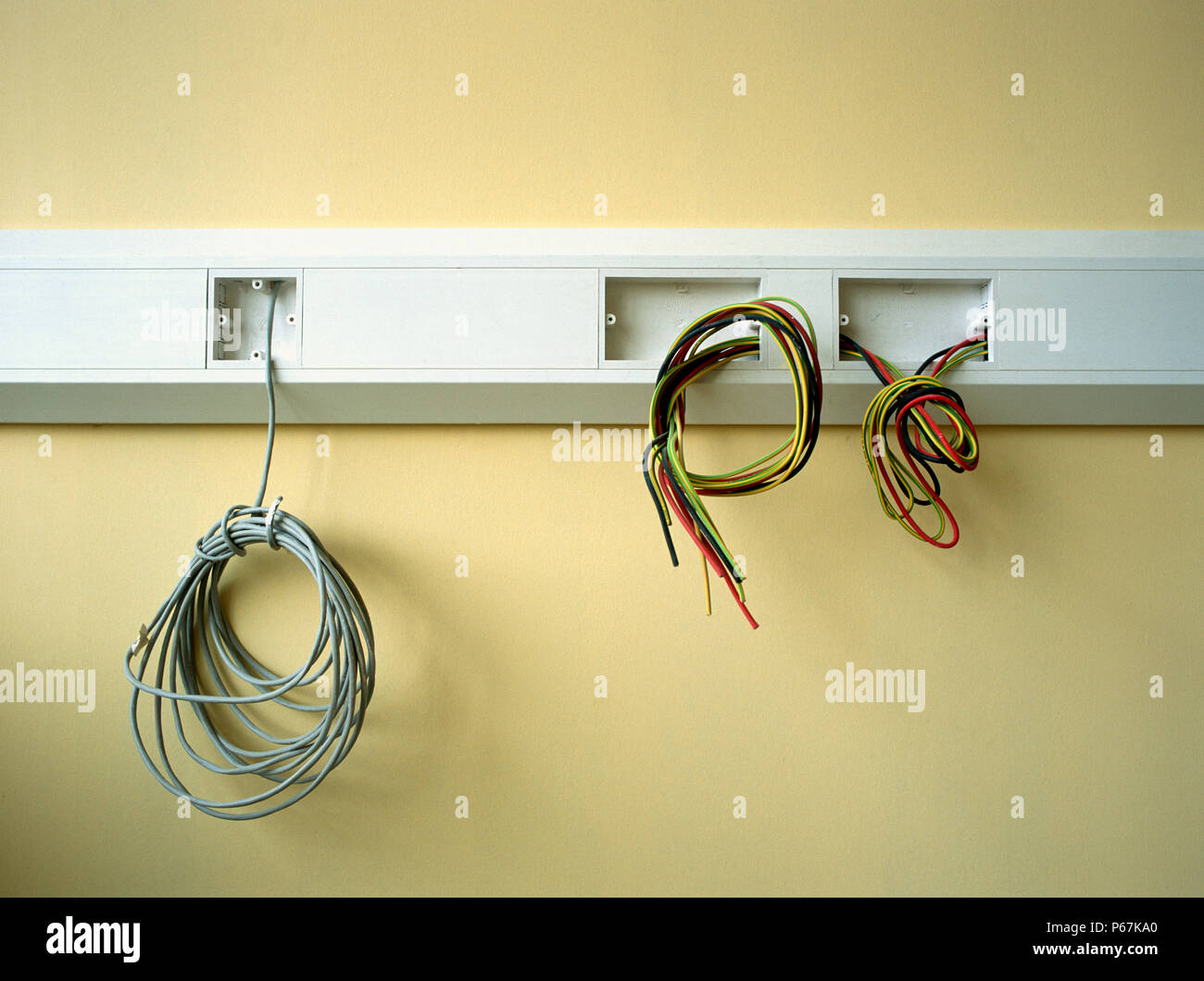 Electrical wires hanging out on a wall Stock Photo Alamy