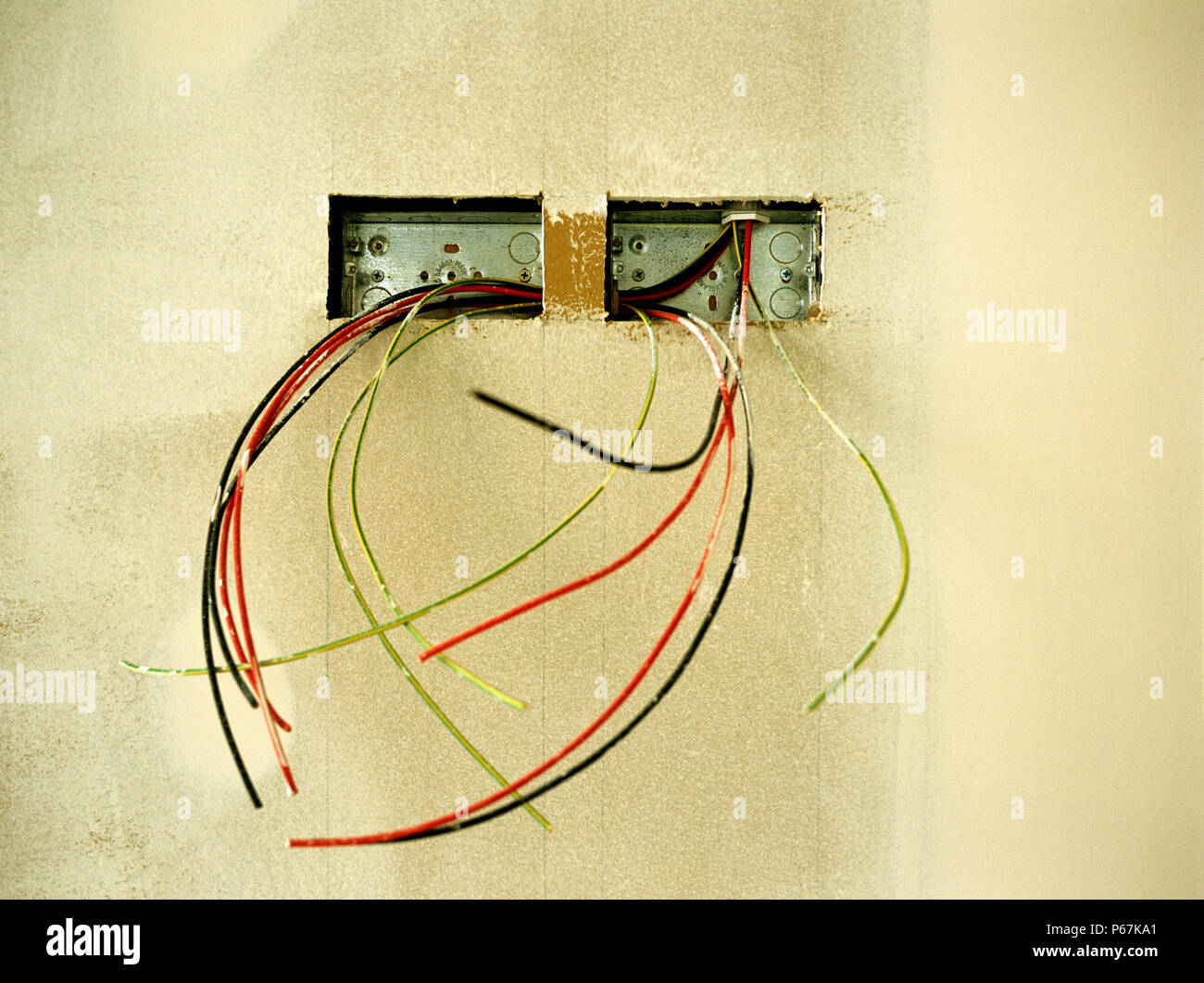 Electrical wires hanging out on a wall Stock Photo Alamy