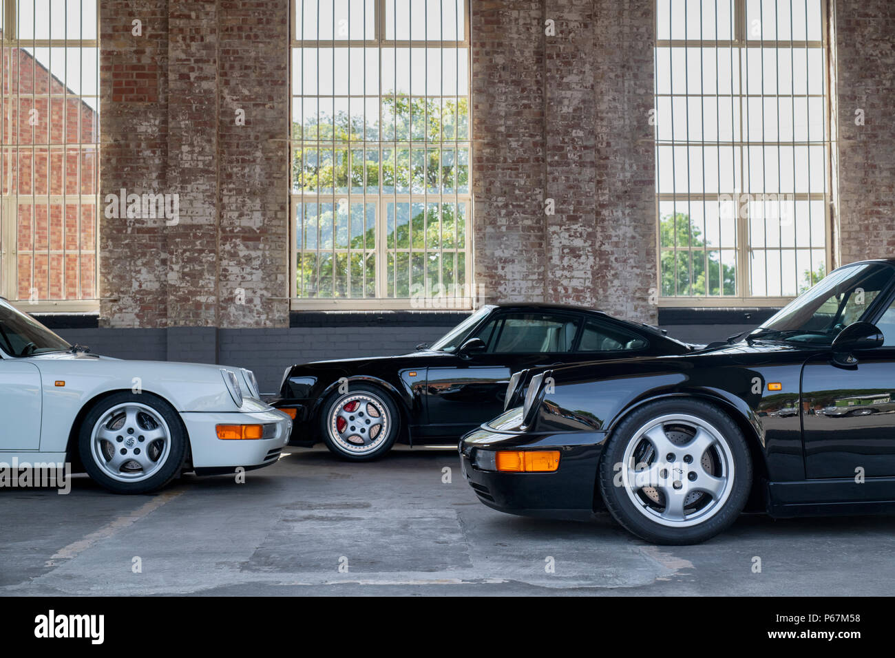 Porsche cars in garage at Bicester heritage centre. Bicester, Oxfordshire, England Stock Photo